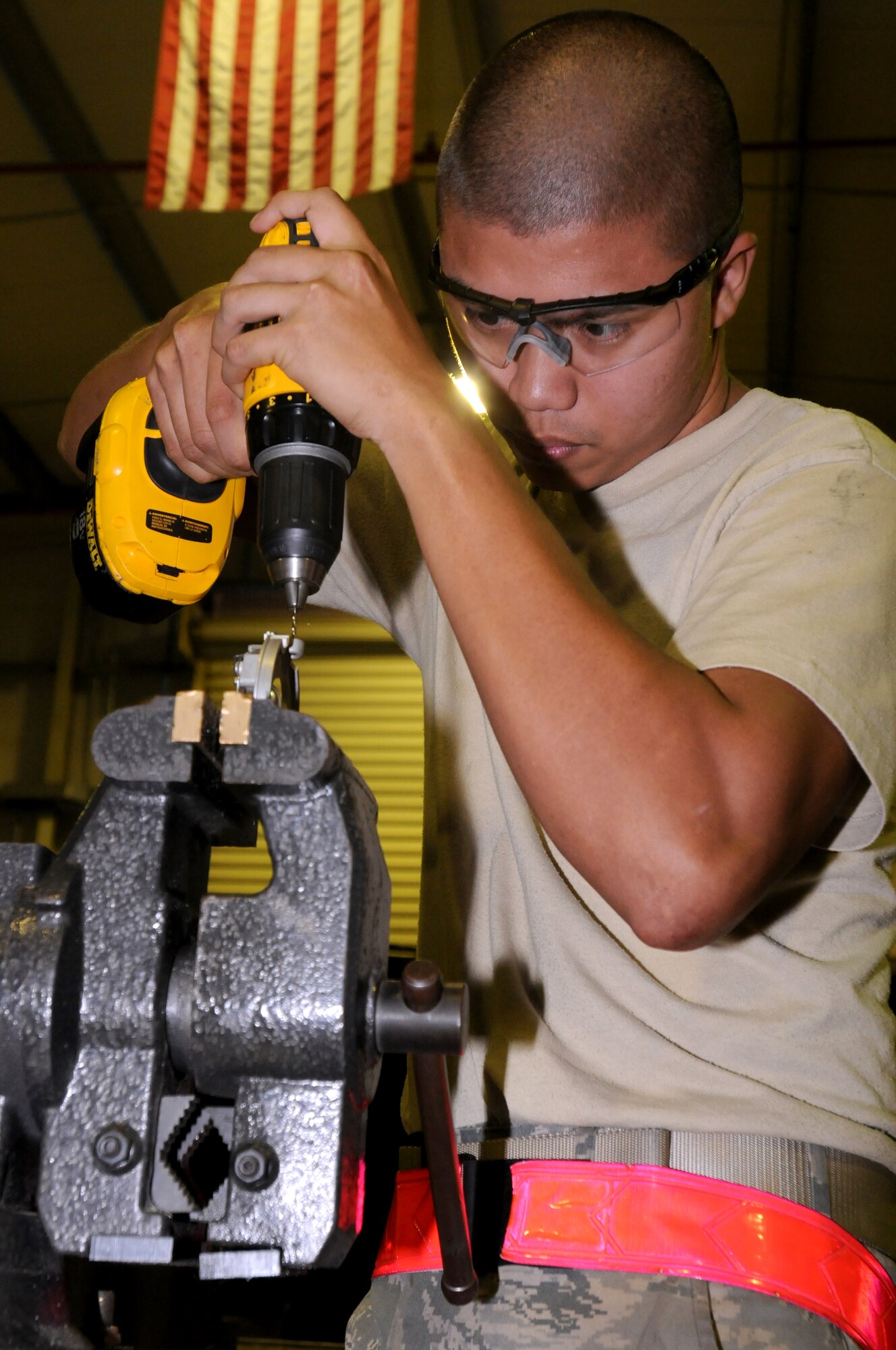 SOUTHWEST ASIA -- U.S. Air Force Senior Airman Mark Calderon, 380th Expeditionary Maintenance Squadron fabrication flight metals technologist, works to remove broken hardware from an aircraft light fixture Nov. 19, 2012. Calderon, a Woodbridge, Va., native, is deployed from Kadena Air Base, Japan. (U.S. Air Force photo/Tech. Sgt. Amanda Savannah)