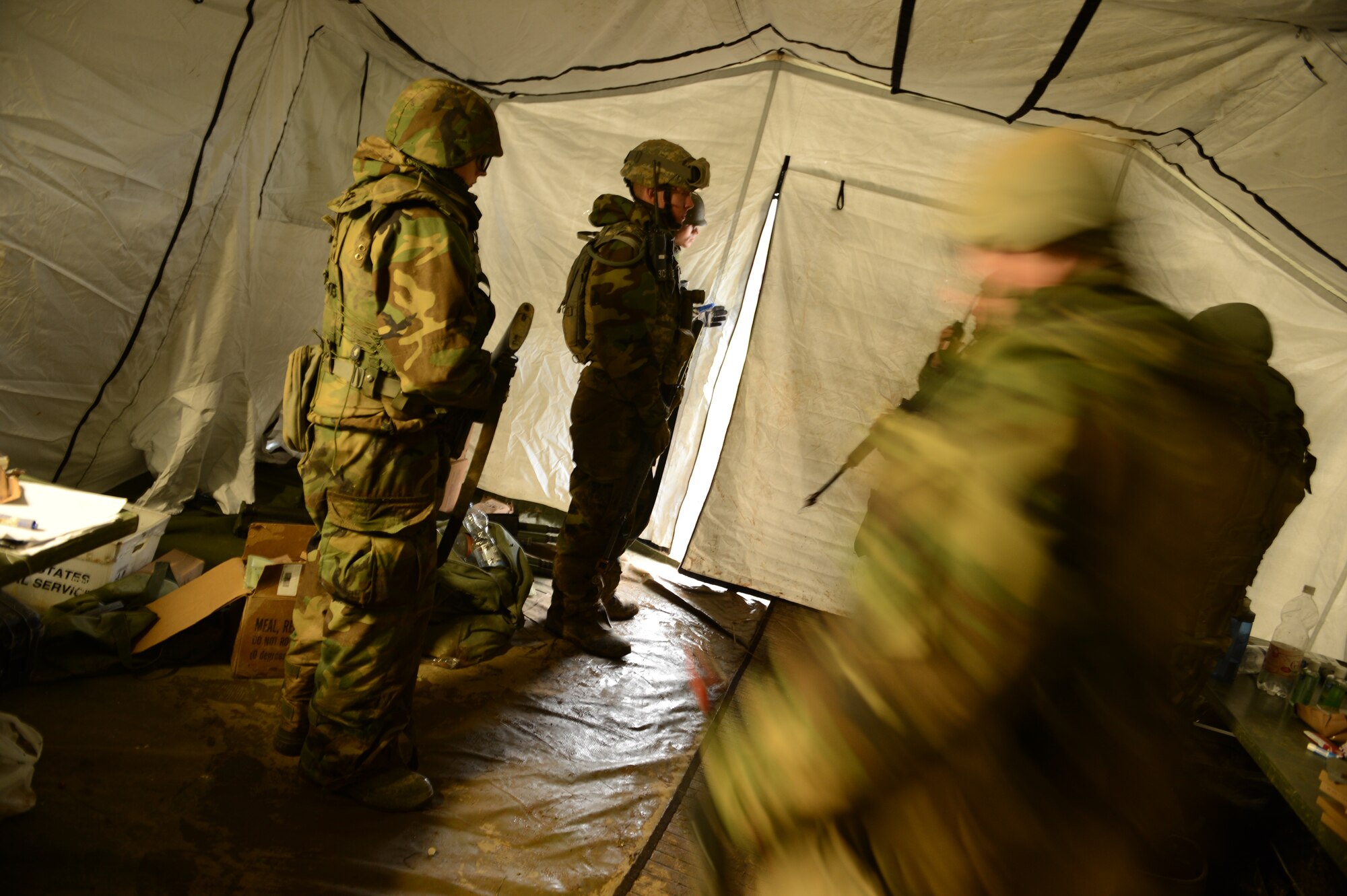 SPANGDAHLEM AIR BASE, Germany – Airmen from the 606th Air Control Squadron discuss base defense procedures inside a makeshift command post as their base is attacked during combat readiness training Nov. 15, 2012. The training prepares Airmen for real-world contingency operations around the world. (U.S. Air Force photo by Staff Sgt. Nathanael Callon/Released)