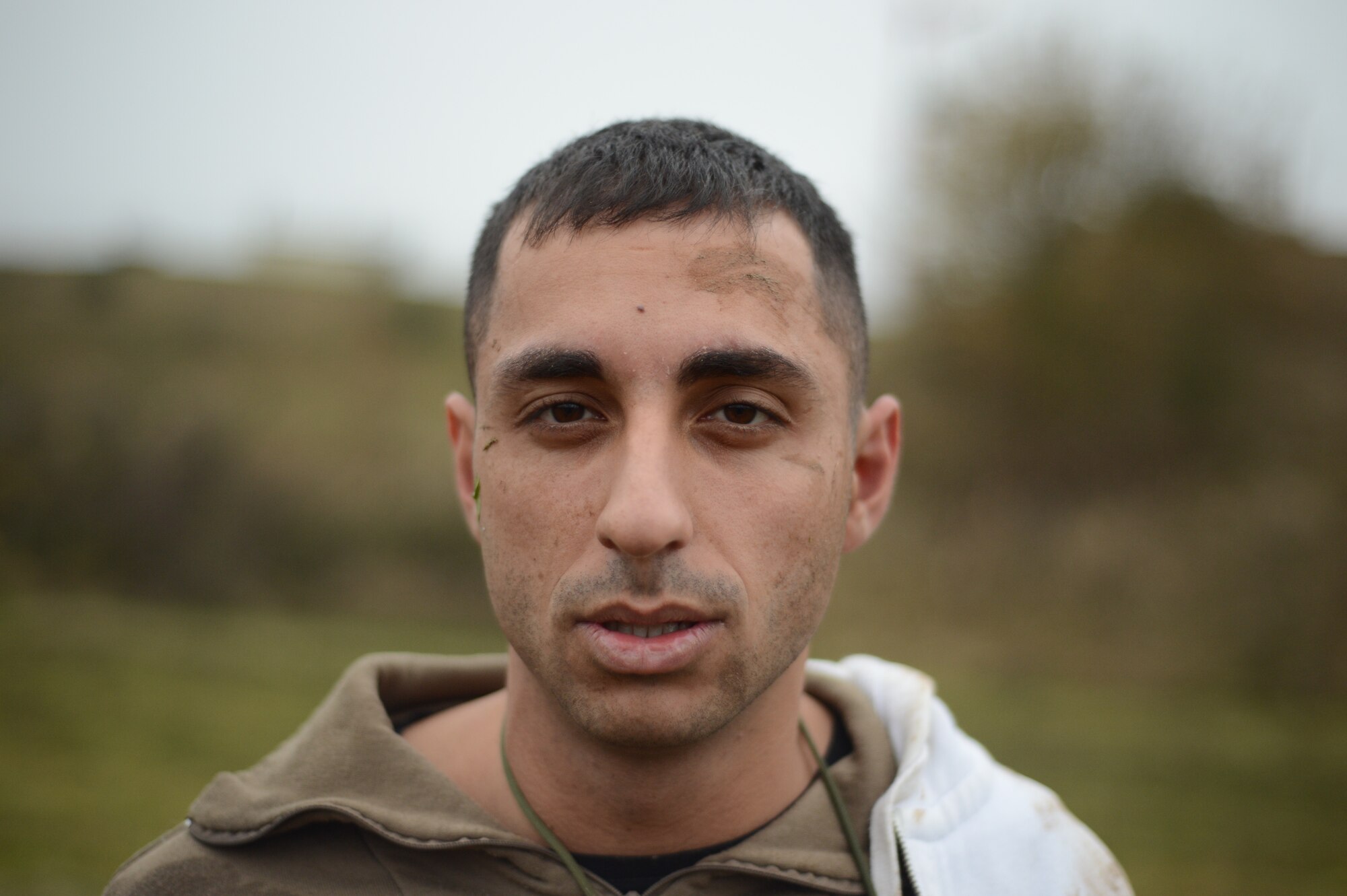 SPANGDAHLEM AIR BASE, Germany – U.S. Air Force Senior Airman Babak Kermanshahi, 606th Air Control Squadron trainer from Jacksonville, Fla., stands after a training scenario where he detonated a simulated improvised explosive device inside the base during combat readiness training Nov. 15, 2012. The trainees searched him on the base after detaining him, which gave him an opportunity to take out as many people as he could. The training provides a controlled platform for the trainees, so they can learn from mistakes they make without real-world retribution. (U.S. Air Force photo by Staff Sgt. Nathanael Callon/Released)