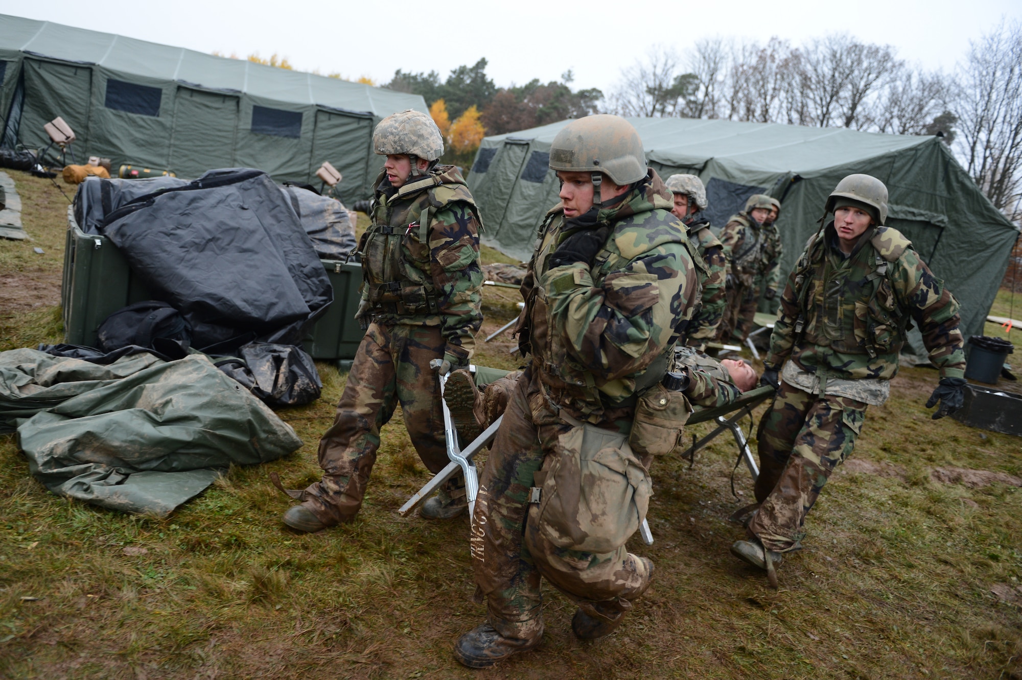 SPANGDAHLEM AIR BASE, Germany – Airmen assigned to the 606th Air Control Squadron, carry simulated casualties to a safe location during combat readiness training Nov. 15, 2012. The combat readiness training ensured that participants were able to perform medical and survival skills in a stressful environment before they are capable of deploying. (U.S. Air Force photo by Airman 1st Class Dillon Davis/Released)