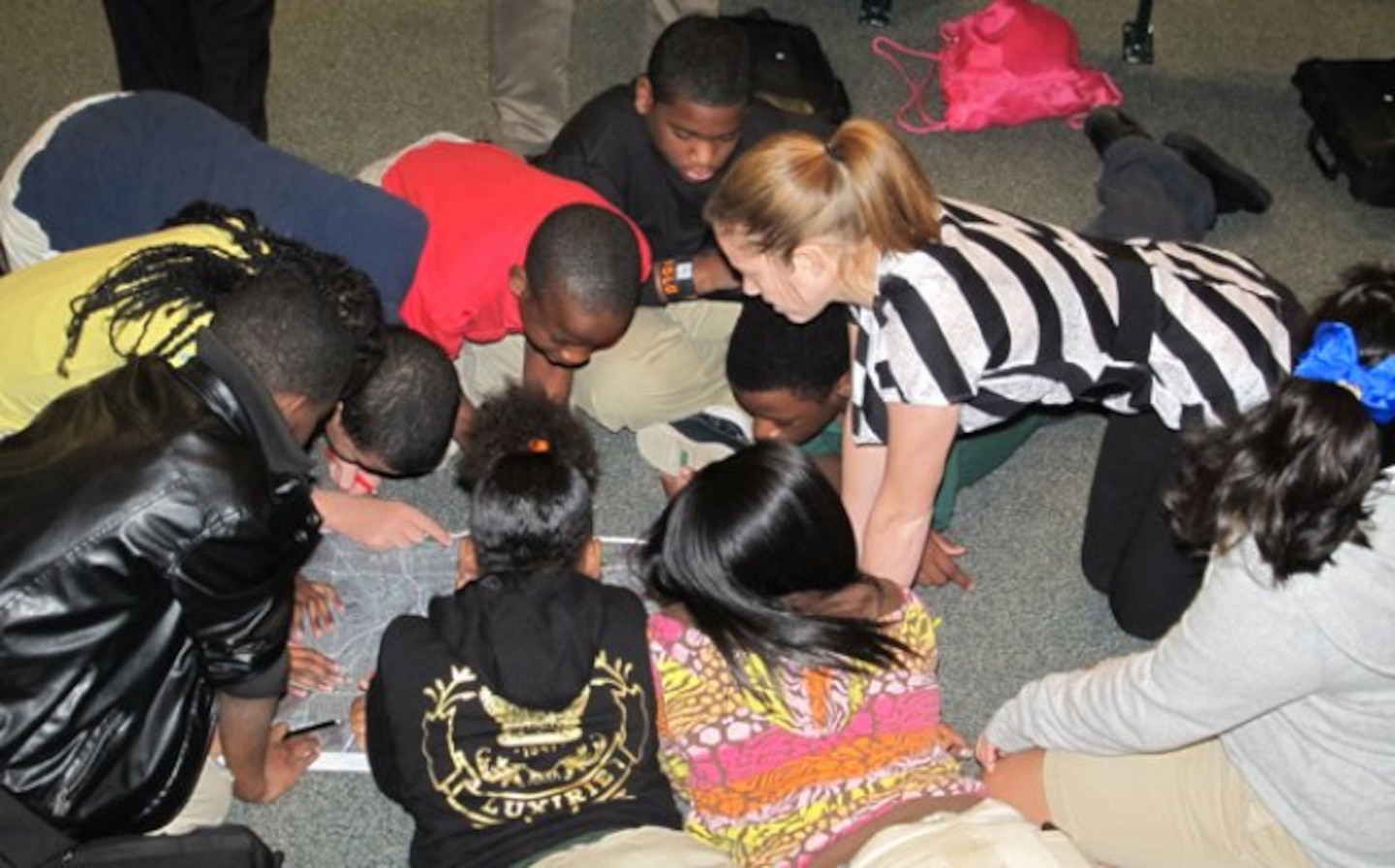 Molly Richardson, right, intern at Huntsville Center, helps sixth-graders at Ed White Middle School in Huntsville, Ala. during a Geographic Information System activity Nov. 14 at the school. More than 150 sixth-graders participated in the GIS Day workshop led by the Corps of Engineers Huntsville Center employees. The school was among six schools in Alabama that observed GIS Day.