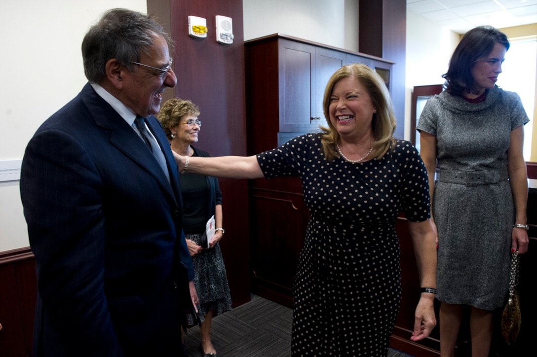 Defense Secretary Leon E. Panetta laughs with Karen Kelly, wife of Marine Corps Gen. John F. Kelly, at the U.S. Southern Command's change-of-command ceremony in Miami, Nov. 19, 2012.