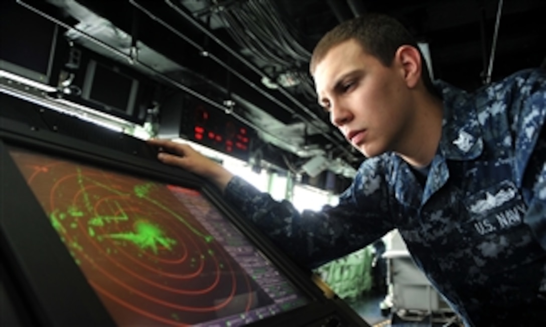 U.S. Navy Petty Officer 2nd Class Michael R. Gutermuth reads the SPS 73 radar on the bridge of the amphibious transport dock ship USS San Antonio (LPD 17) as the ship prepares to get underway from Norfolk, Va., on Oct. 30, 2012.  Gutermuth is a Navy operations specialist. 