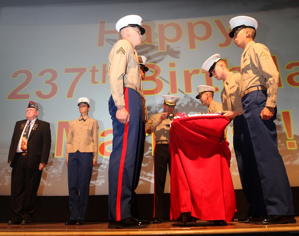 The oldest Marine present, retired Sgt. Maj. Bill Paxton, takes the first bite of cake during a cake-cutting ceremony aboard Marine Corps Air Station Miramar, Calif., Nov. 9. During the yearly ceremony, the oldest Marine takes a bite of cake then passes the cake to the youngest Marine present to symbolize the passing of wisdom from one generation of Marines to the next.