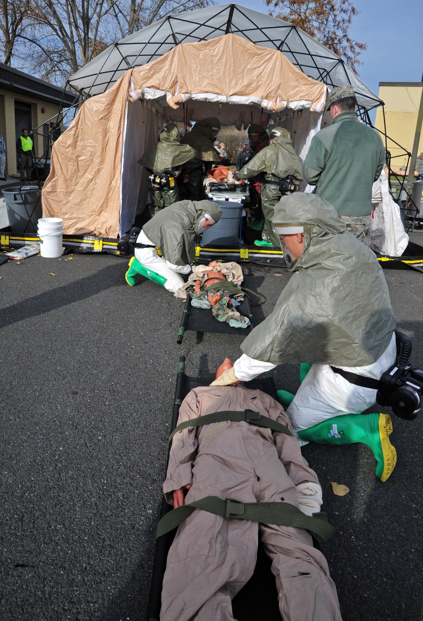 Members of the 92nd Medical Group check for signs of breathing on a simulated victim of chemical warfare during an exercise at Fairchild Air Force Base, Wash., Nov. 7, 2012. During the exercise, Airmen learned to better integrate emergency response training and assessments for exercise evaluation teams. (U.S. Air Force photo by Airman 1st Class Taylor Curry)