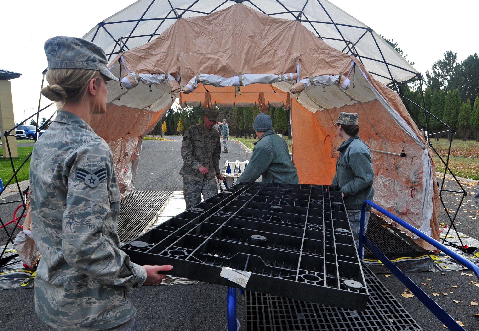 Members of the 92nd Medical Group prepare an in-place patient decontamination tent during a simulated chemical-warfare attack, Nov. 7, 2012. During the exercise, Airmen learned to better integrate emergency response training and assessments for exercise evaluation teams. (U.S. Air Force photo by Airman 1st Class Taylor Curry)