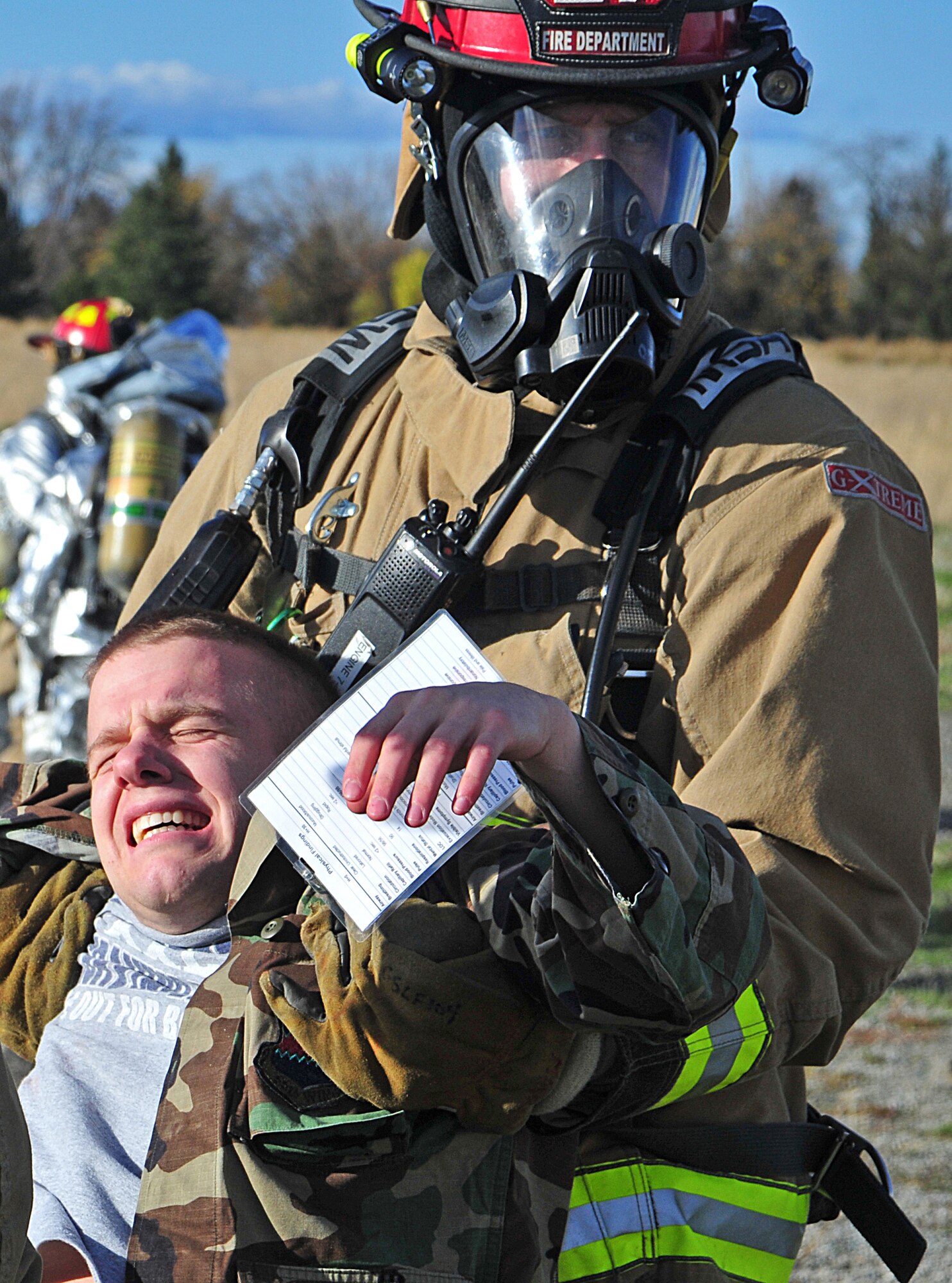 A 92nd Civil Engineering Squadron firefighter carries away Senior Airman Ryan Berends, a simulated victim of an explosive device attack during an exercise at Fairchild Air Force Base, Wash., Nov. 7, 2012. During the exercise, Airmen learned to better integrate emergency response training and assessments for exercise evaluation teams. Berends is a diagnostic imaging technician from the 92nd Medical Support Group. (U.S. Air Force photo by Airman 1st Class Taylor Curry)