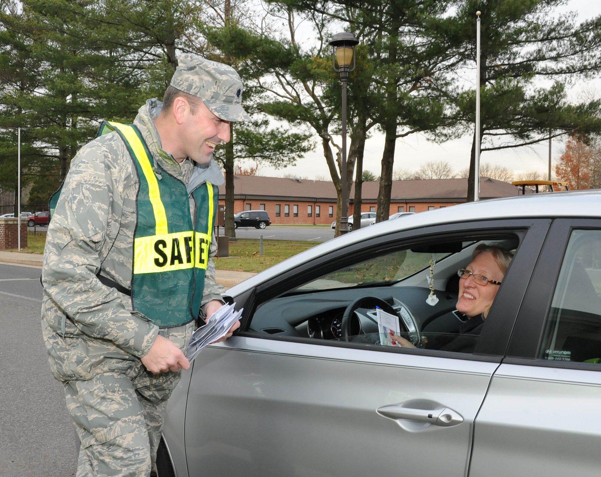 Lt. Col. David Brickley, Joint Base McGuire-Dix-Lakehurst Safety director, hands out information to drivers Nov. 21, 2012, at Joint Base MDL, N.J. The base’s senior leaders, along with base safety personnel, disseminated winter-safety information and wished all members a safe and happy holiday.  (U.S. Air Force photo by Airman Sean Crowe/Released)