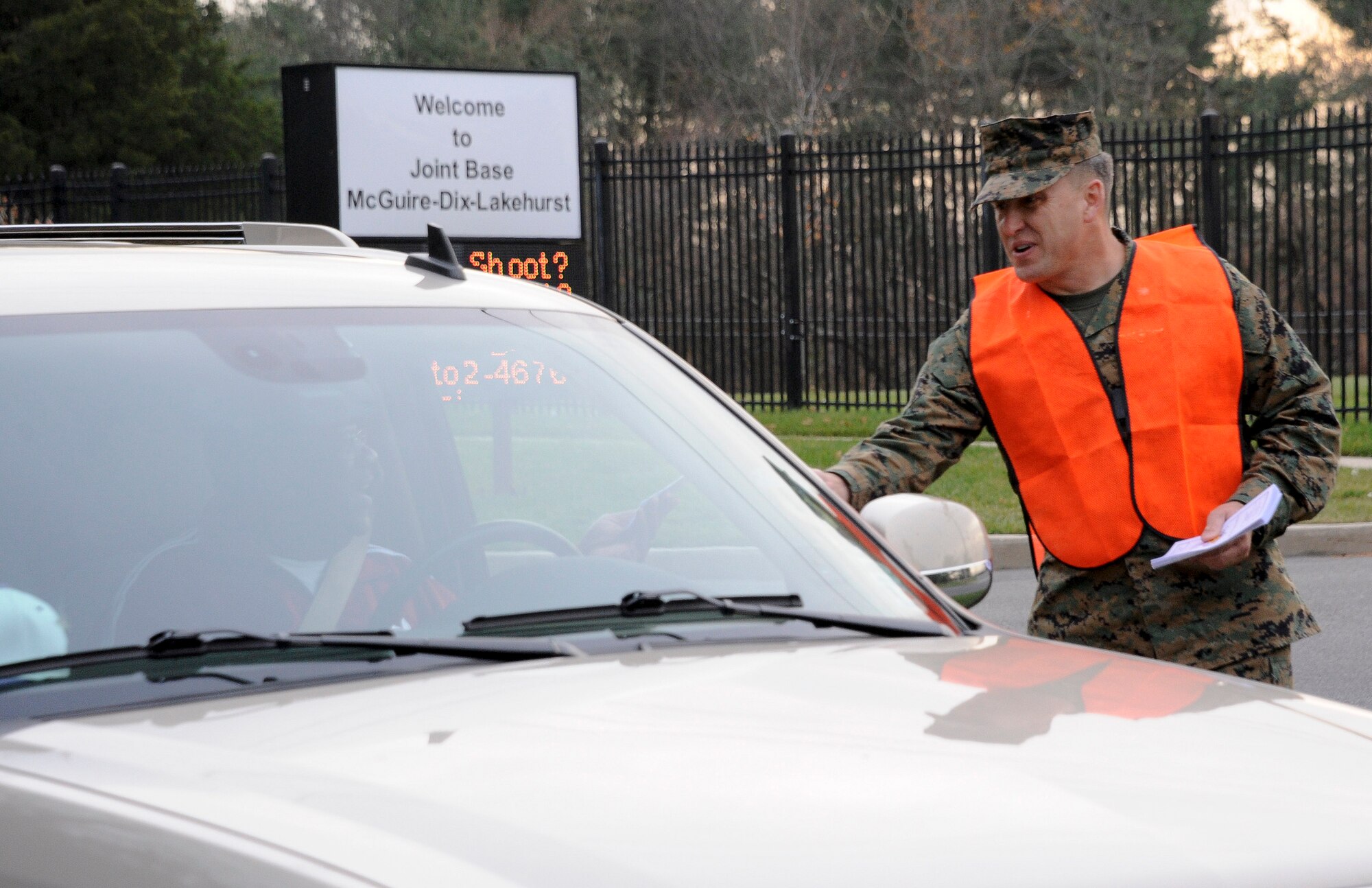 Lt. Col. William Moryto, Marine Aircraft Group 49 director of safety, greets Joint Base McGuire-Dix-Lakehurst community members Nov. 20, 2012, as they exit the Wrightstown Gate. The base’s senior leaders, along with base safety personnel, wished all members a safe and happy holiday. (U.S Air Force photo by Airman 1st Class Ryan Throneberry/Released)