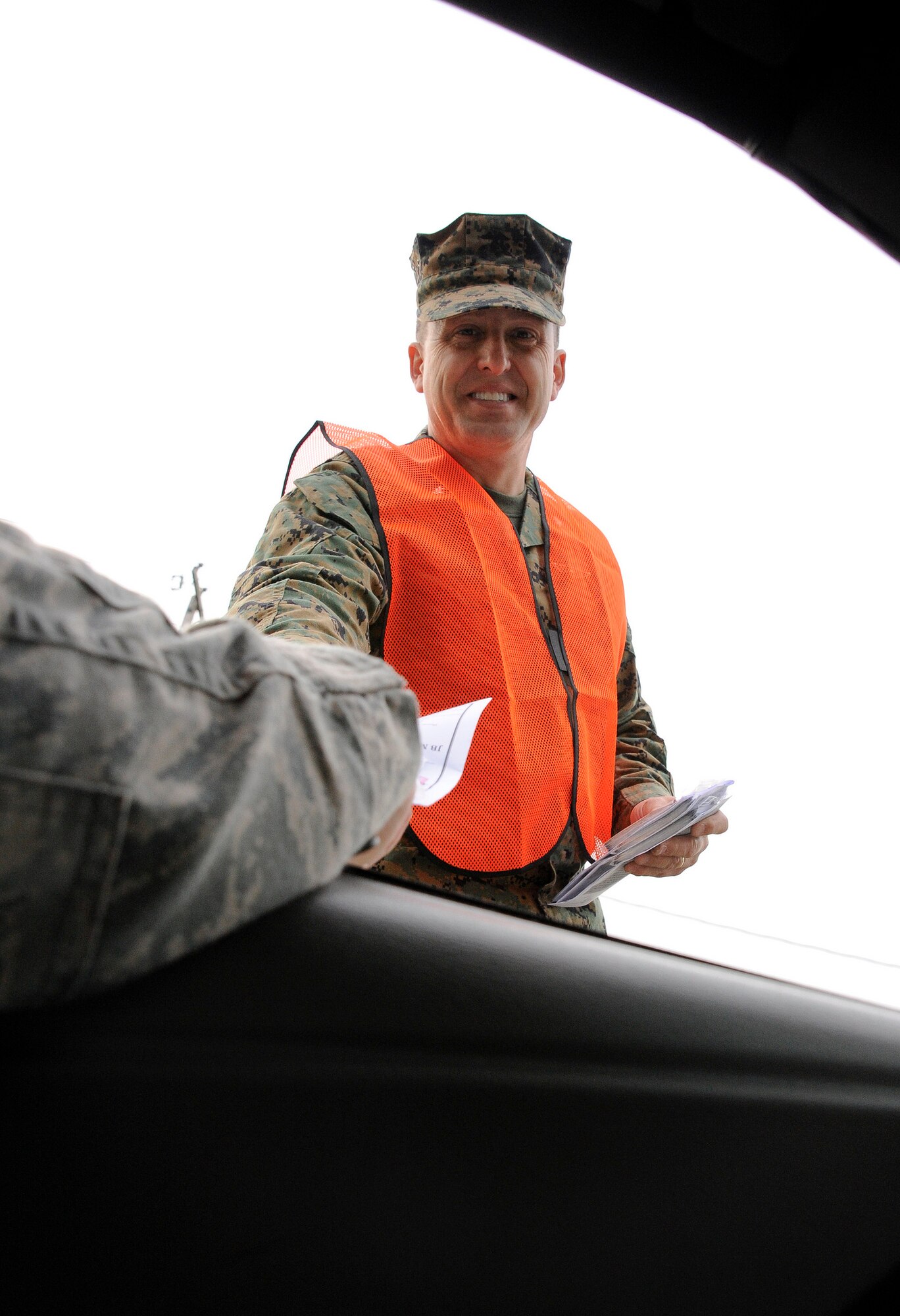 Lt. Col. William Moryto, Marine Aircraft Group 49 director of safety, greets Joint Base McGuire-Dix-Lakehurst community members Nov. 20, 2012, as they exit the Wrightstown Gate. The base’s senior leaders, along with base safety personnel, wished all members a safe and happy holiday. (U.S Air Force photo by Airman 1st Class Ryan Throneberry/Released)