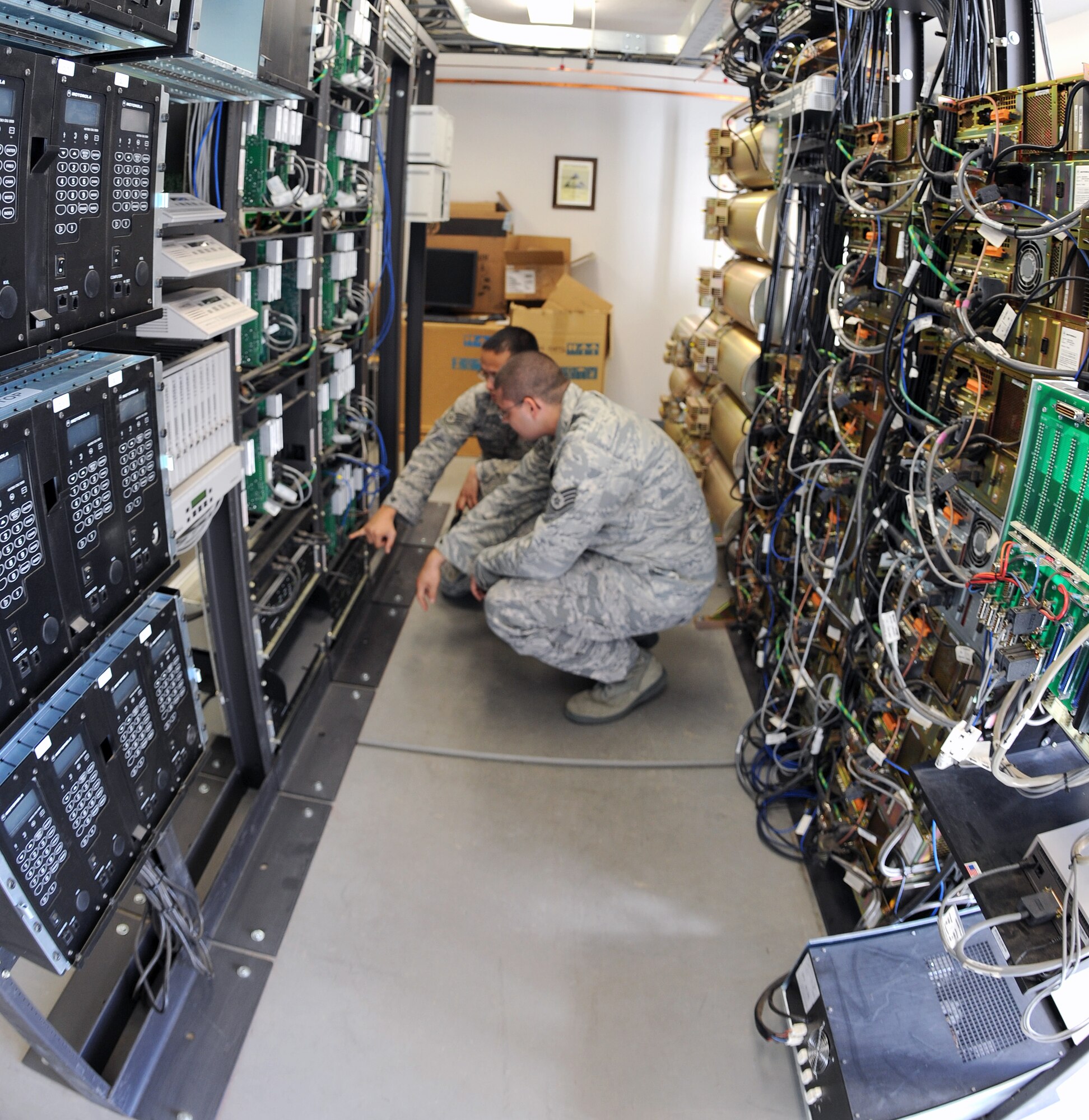 U.S. Air Force Staff Sgts. Adam Heimbecker and Joseph Carr, 355th Communication Squadron discuss the instillation of a new trunking system on Davis-Monthan Air Force Base, Ariz., Nov. 20.  (U.S. Air Force photo by Senior Airman Brittany Dowdle)