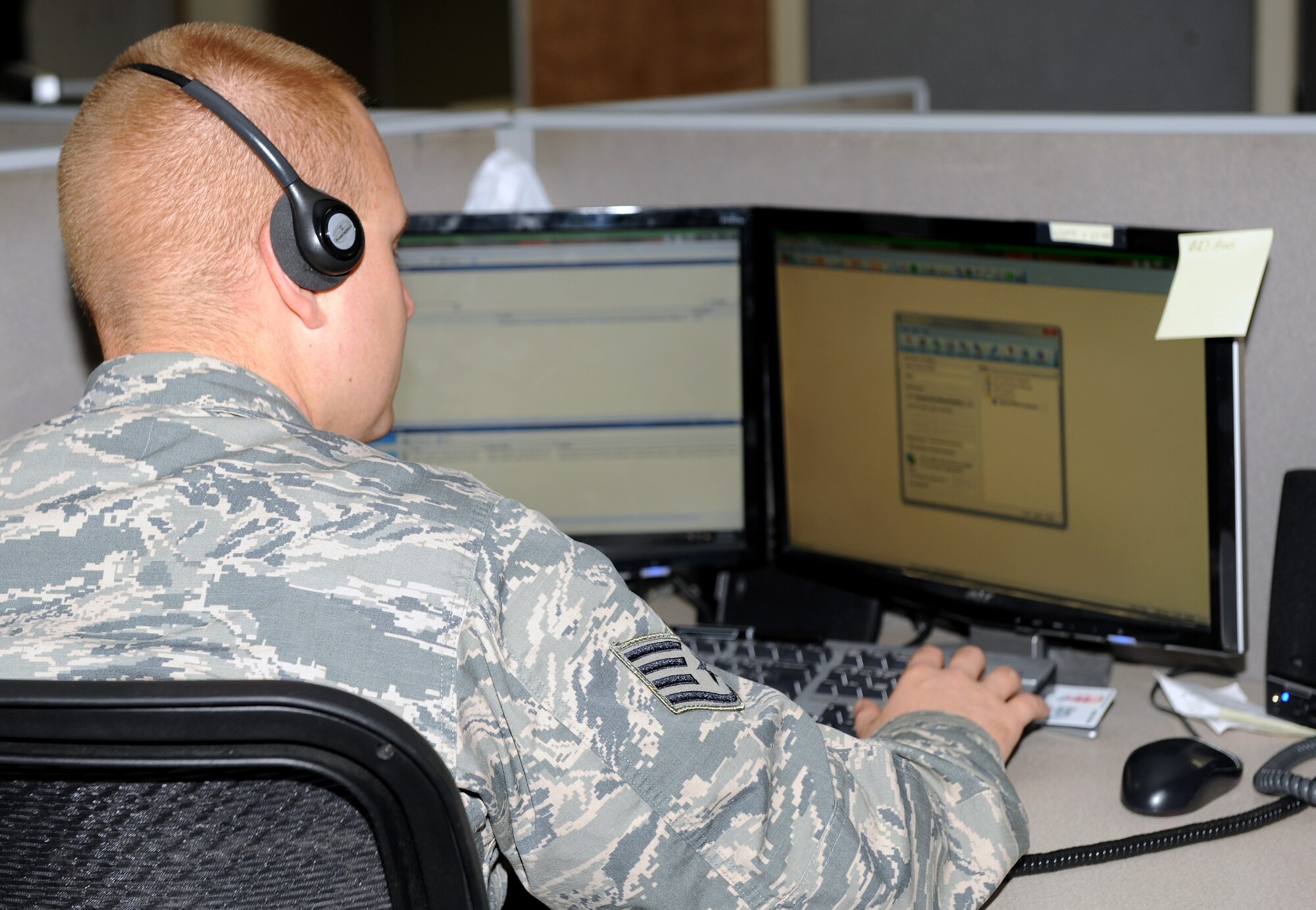 U.S. Air Force Staff Sgt. Ryan Lloyd, 355th Communication Squadron client systems technician, assists a customer on the phone as he prepares to remote into the customers computer on Davis-Monthan Air Force Base, Ariz., Nov. 20. (U.S. Air Force photo by Senior Airman Brittany Dowdle)