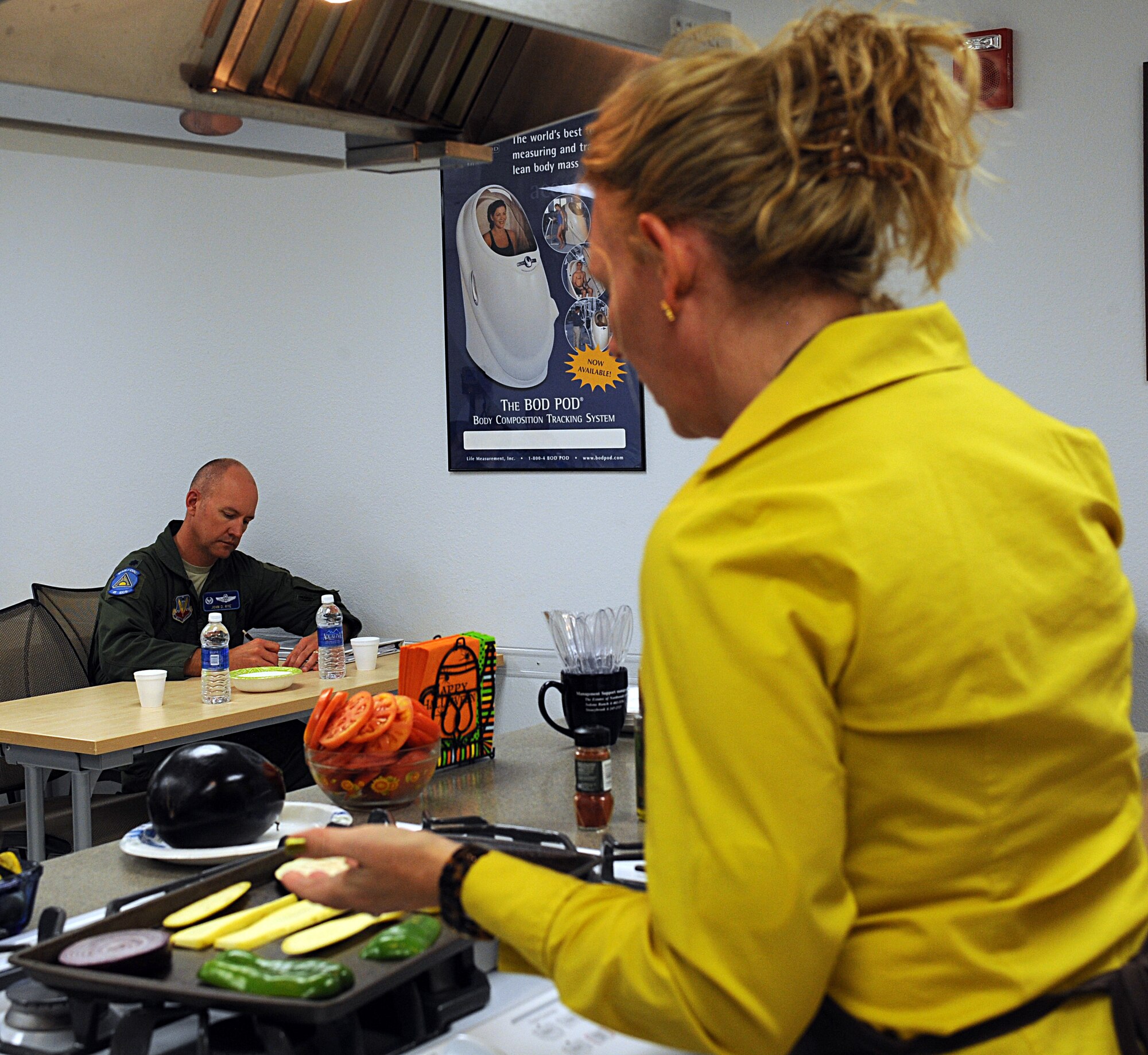 U.S. Air Force Lt. Col. John Rye, 41st Electronic Combat Squadron commander, takes notes as Cindy Davis, Health and Wellness Center dietician, demonstrates a way to bake vegetables during the cooking demonstration of the Commander's 101/Surviving the Holidays course on Davis-Monthan Air Force Base, Ariz., Nov. 14, 2012. Colonel Rye and other members of the base community took the course to learn ways to help themselves and their Airmen improve their overall health and lifestyles. (U.S. Air Force photo by Senior Airman Timothy Moore/Released)