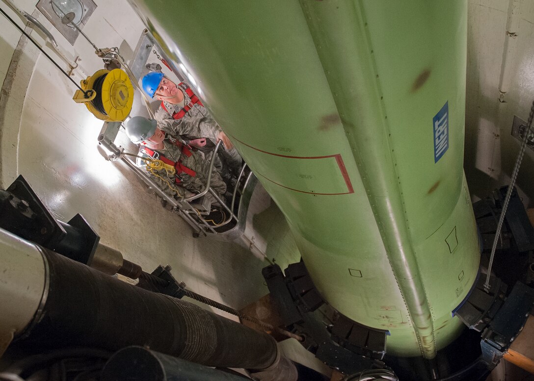 Air Force Chief of Staff Gen. Mark A. Welsh III and Tech. Sgt. Justin Richie, a 341st Maintenance Operations Squadron team trainer, ride in a work cage, Nov. 20, inside the T-9 maintenance trainer at Malmstrom Air Force Base, Mont. (U.S. Air Force photo/Beau Wade)