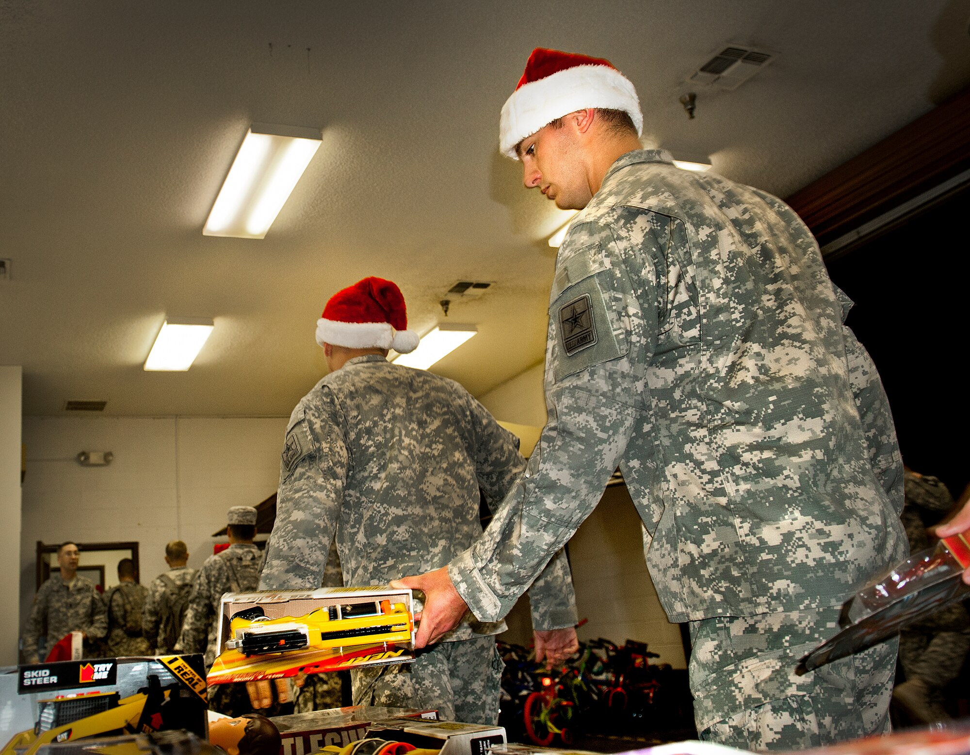 Soldiers from the Army Detachment of the Naval School Explosive Ordnance Disposal deliver toys to the Airman’s Attic at Eglin Air Force Base, Fla. Nov. 20. The toys, costing no more than $15, are donations to the Attic for distribution to active-military families on Nov. 29th. (U.S. Air Force photo/Randy Gon)