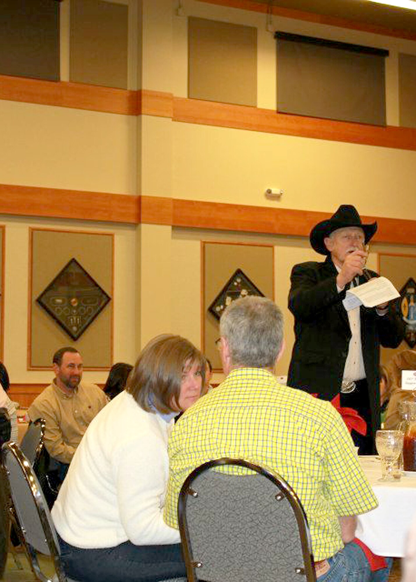 Fred Buror, auctioneer, calls out bids for items during the live auction at the event.  There were various items up for auction, including a wagon full of children’s’ toys, jewelry, purses and an outdoor wood stove. (U.S. Courtesy Photo)