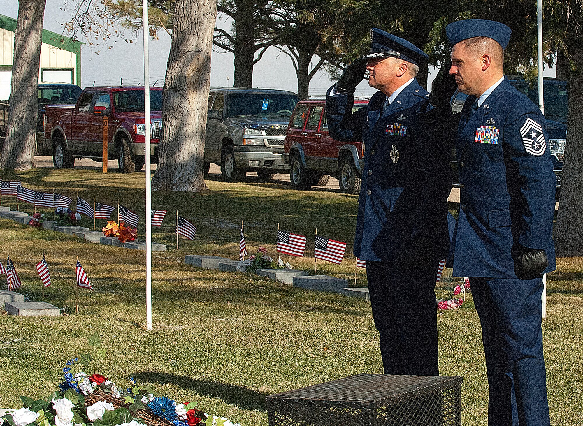 Col. Chris Coffelt, 90th Missile Wing commander, and Chief Master Sgt. Michael Garrou, 90th Missile Wing command chief, salute the flag after laying a wreath at the veteran’s memorial during a Veteran’s Day ceremony in Cheyenne’s Beth El cemetery the morning of Nov. 11. The 90th Missile Wing was among several organizations honoring veterans with wreaths including the governor of Wyoming and the mayor of Cheyenne. (U.S. Air Force photo by R.J. Oriez)