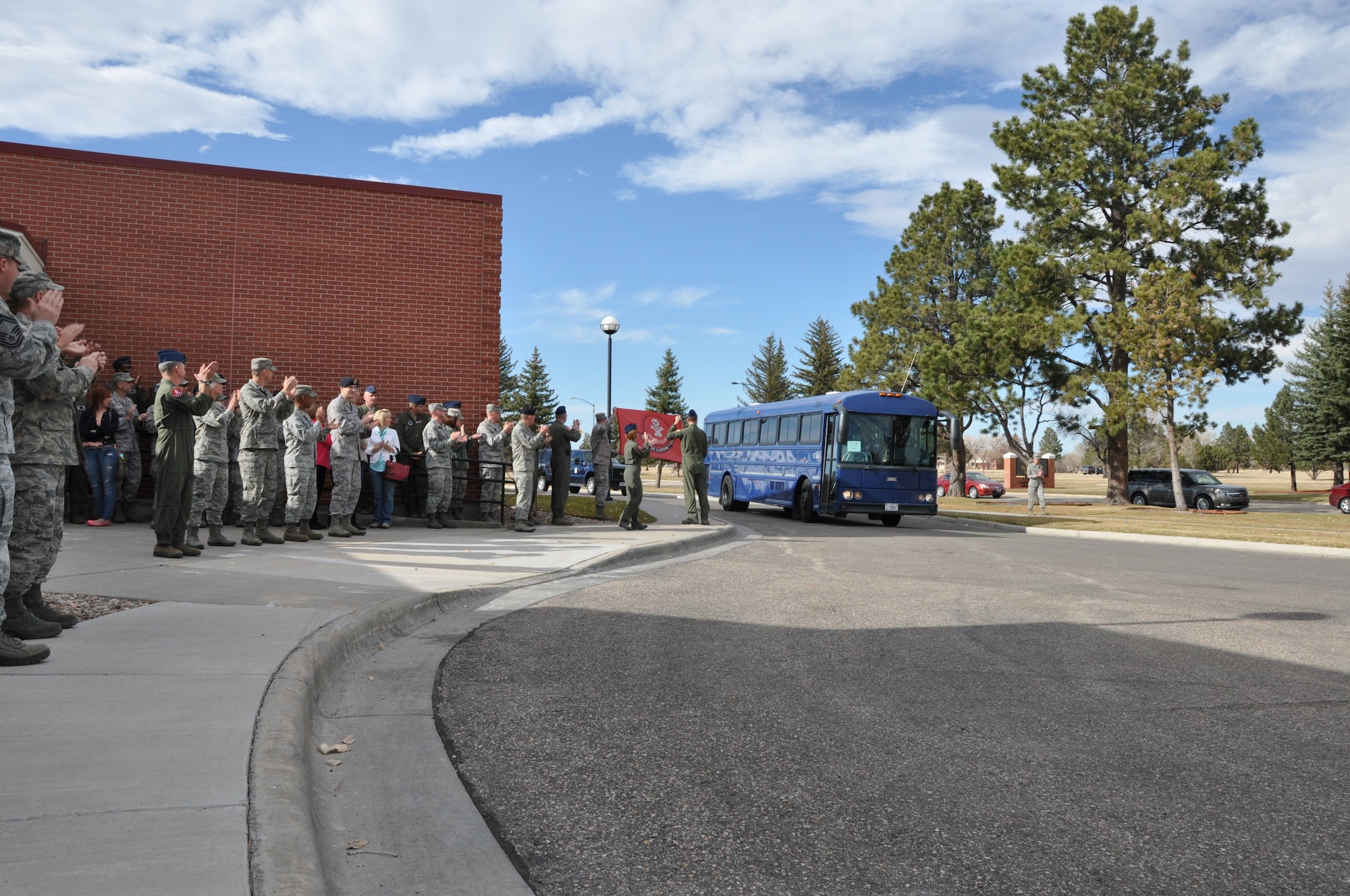 Mighty Ninety members line the sidewalk of the Trail's End Club Nov 8 as the Warren Wranglers make their way into the building for a welcome-home celebration. (U.S. Air Force photo by Senior Airman Dan Gage)