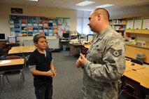 Staff Sgt. John Reuter, a member of the 115th Fighter Wing’s Security Forces Squadron, talks with a student at Clarendon Avenue Elementary School in Mukwonagon, Wis., November 20, 2012.  Reuter was at the school to meet with students from the winning classes of a care package drive the school hosted. (National Guard photo by 2nd. Lt. Stephen Montgomery)