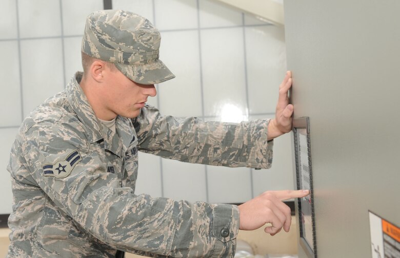 Airman 1st Class Brian Stanyer, 2nd Civil Engineer Squadron Heating, Ventilation, Air Conditioning and Refrigeration apprentice adjusts set points on a Trane chiller on Barksdale Air Force Base, La., Nov. 20. HVAC and Energy Management Control System flight controls and repairs the heating and cooling systems in more than 900 facilities across the base. (U.S. Air Force photo/Senior Airman Kristin High)(RELEASED)
