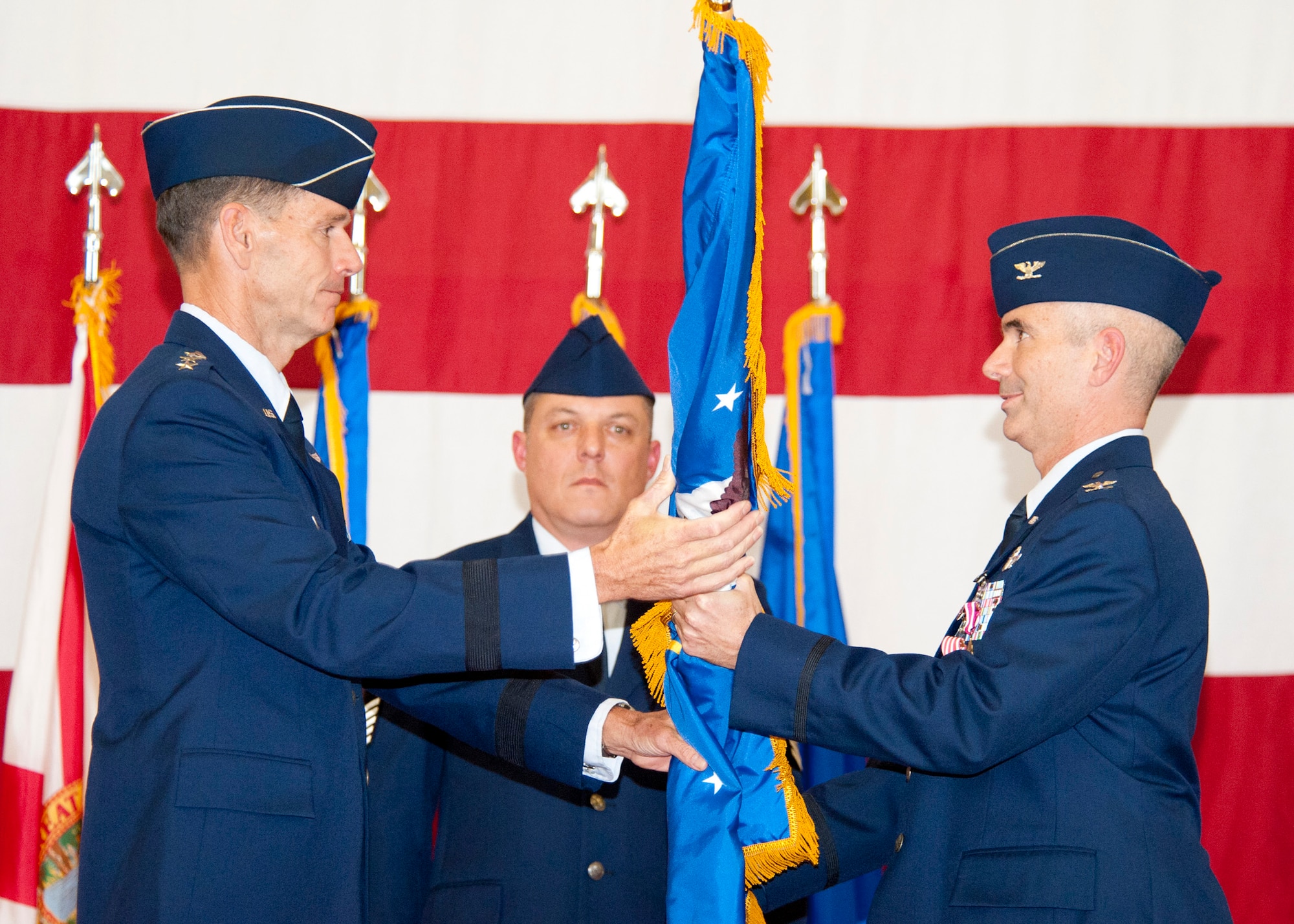 U.S. Air Force Lt. Gen. Sid Clarke, left, Commander of Continental United States North American Aerospace Defense Command Region and First Air Force (Air Forces Northern), passes the 601st Air and Space Operations Center (601st AOC) flag to Col. Thomas Cucchi during a change of command ceremony held here Nov. 20, 2012. The 601st AOC is responsible for detecting, deterring, defending and if necessary, defeating any aviation threat to the citizens of the United States and to U.S. critical infrastructure. (U.S. Air Force photo by Lisa Norman/Released)