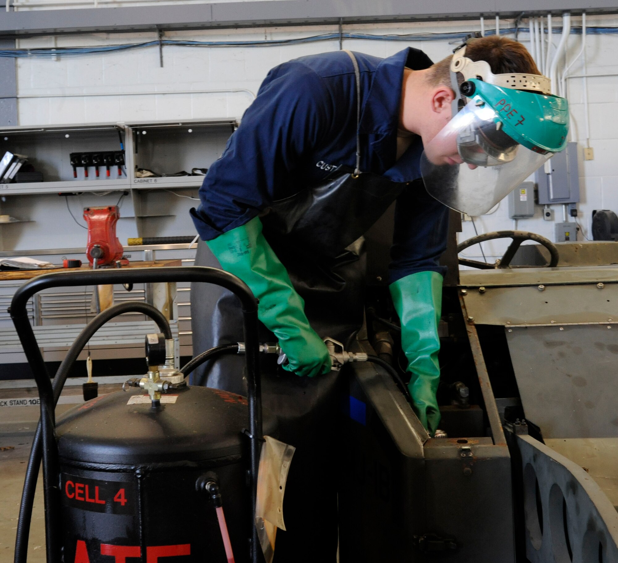 Senior Airman Michael Custodio, 707th Maintenance Squadron, refills hydraulic fluid on a bomb lift on Barksdale Air Force Base, La., Nov. 19. These lifts are one of the most common items the maintenance section works on, and are one of the most vital as they are used to transport and help secure bombs to hard points on the B-52H Stratofortress. (U.S. Air Force photo/Airman 1st Class Andrew Moua)(RELEASED)