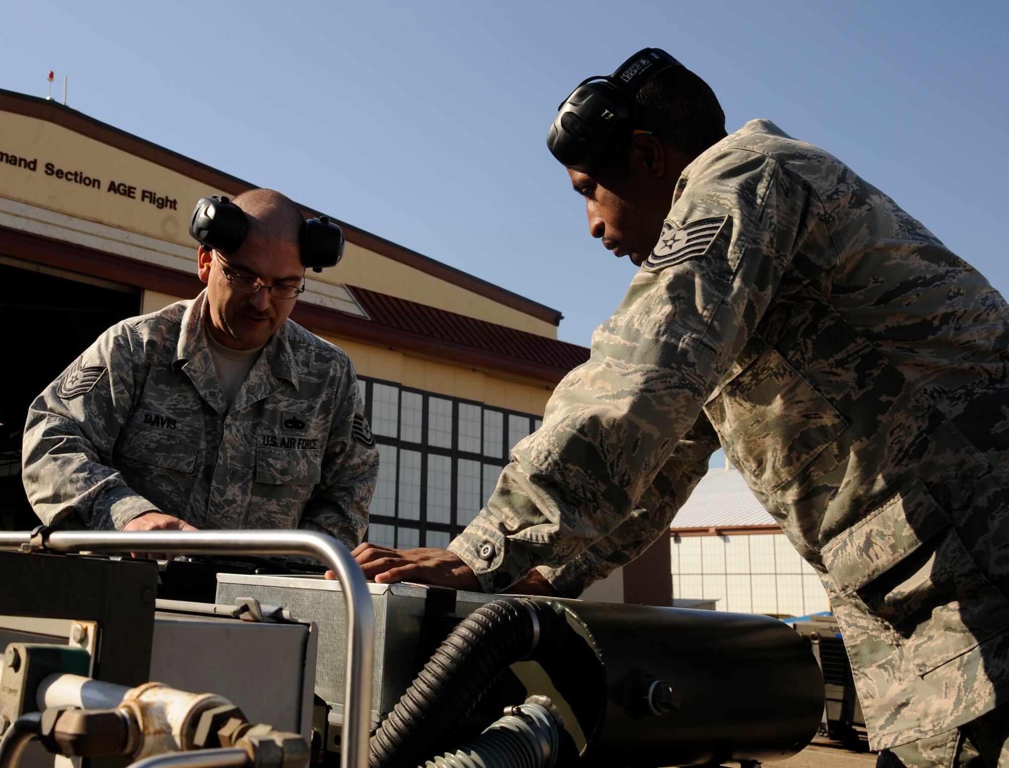 Tech. Sgt. David Davis, 2nd Maintenance Squadron Aerospace Ground Equipment flight NCO in charge of maintenance, and Tech. Sgt. Jamaar Campbell, 2 MXS AGE flight, inspect a malfunctioning piece of equipment on Barksdale Air Force Base, La., Nov. 19. The AGE flight?s responsibilities include quality maintenance, and delivery of equipment to get B-52H Stratofortress bombers into the air and ready to deliver precision munitions to the battlefield. (U.S. Air Force photo/Airman 1st Class Andrew Moua)(RELEASED)