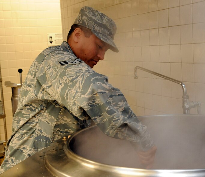 Senior Airman Jose Ortiz, 2nd Force Support Squadron, prepares food for the Red River dining facility lunch on Barksdale Air Force Base, La., Nov. 21. The dining facility will begin preparing turkey, ham, and other dishes for an expected 300-400 diners of the Thanksgiving lunch and dinner, to be held on Thanksgiving Day. (U.S. Air Force photo/Airman 1st Class Andrew Moua)(RELEASED)