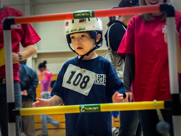 Carl Sole, seven-year old son of Tech. Sgt. Carl Sole, 628th Security Forces Squadron, plays a game of ladder golf Nov. 17, 2012, during the Special Olympics Event at the JB Charleston – Air Base Fitness Center, S.C. The event provided Exceptional Family Member Program members the opportunity to develop physical fitness skills and make connections with other children. (U.S. Air Force photo / Airman 1st Class Tom Brading)