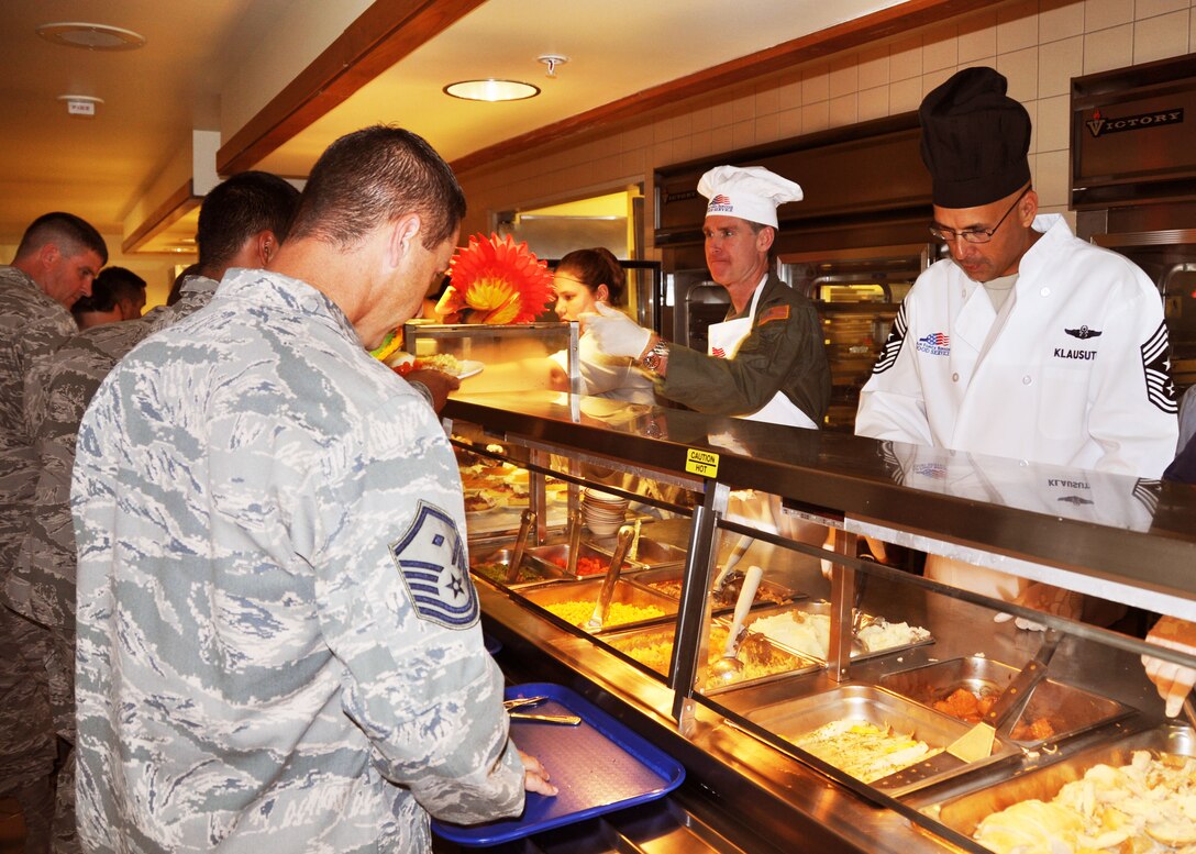 Inside Duke Field’s dining facility, Col. Destry Rogers, the 919th Special Operations Wing vice commander, left, and Chief Master Sgt. Michael Klausutis, the wing’s command chief, serve a traditional Thanksgiving meal for their fellow Air Force reservists at Duke Field, Fla., during the November unit training assembly.  The leaders joined the 919th Force Support Squadron’s DFAC food services team in providing hundreds of the festive meals for their Citizen Commandos to enjoy in advance of the Thanksgiving holiday.  (U.S. Air Force photo/Dan Neely)