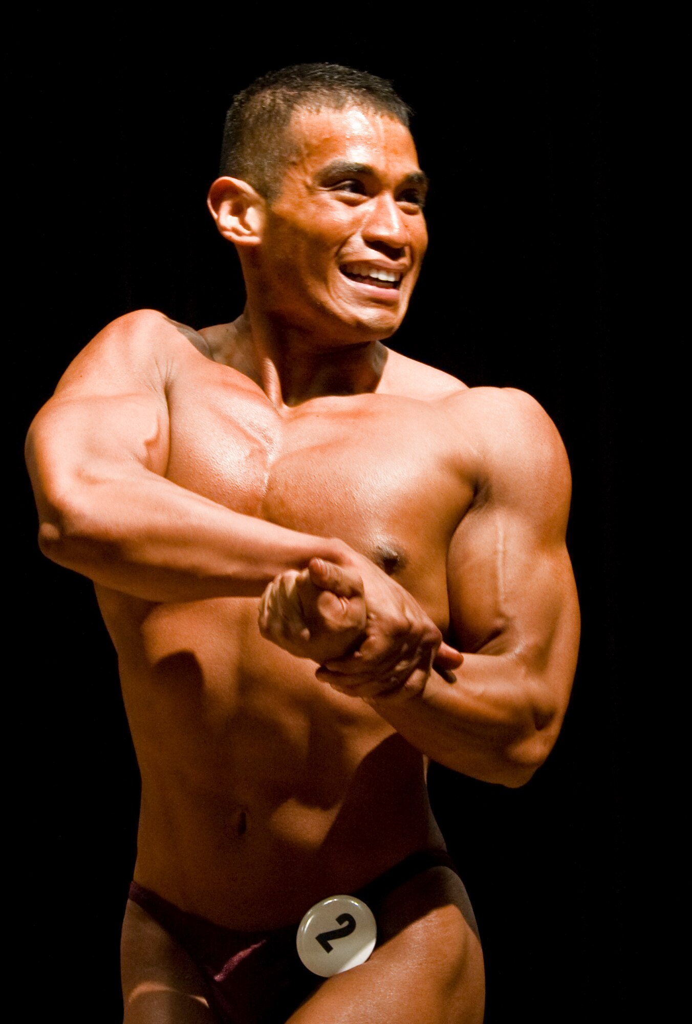 Senior Airman Michael Hernandez, 7th Force Support Squadron, poses for the judges during the men’s open lightweight body building division Nov. 17, 2012, at Dyess Air Force Base, Texas. Six Dyess team members participated in the National Physique Committee sanctioned event held in the base theatre, allowing them to highlight the time and energy put towards perfecting their bodies. (U.S. Air Force photo by Airman 1st Class Peter Thompson/ Released)