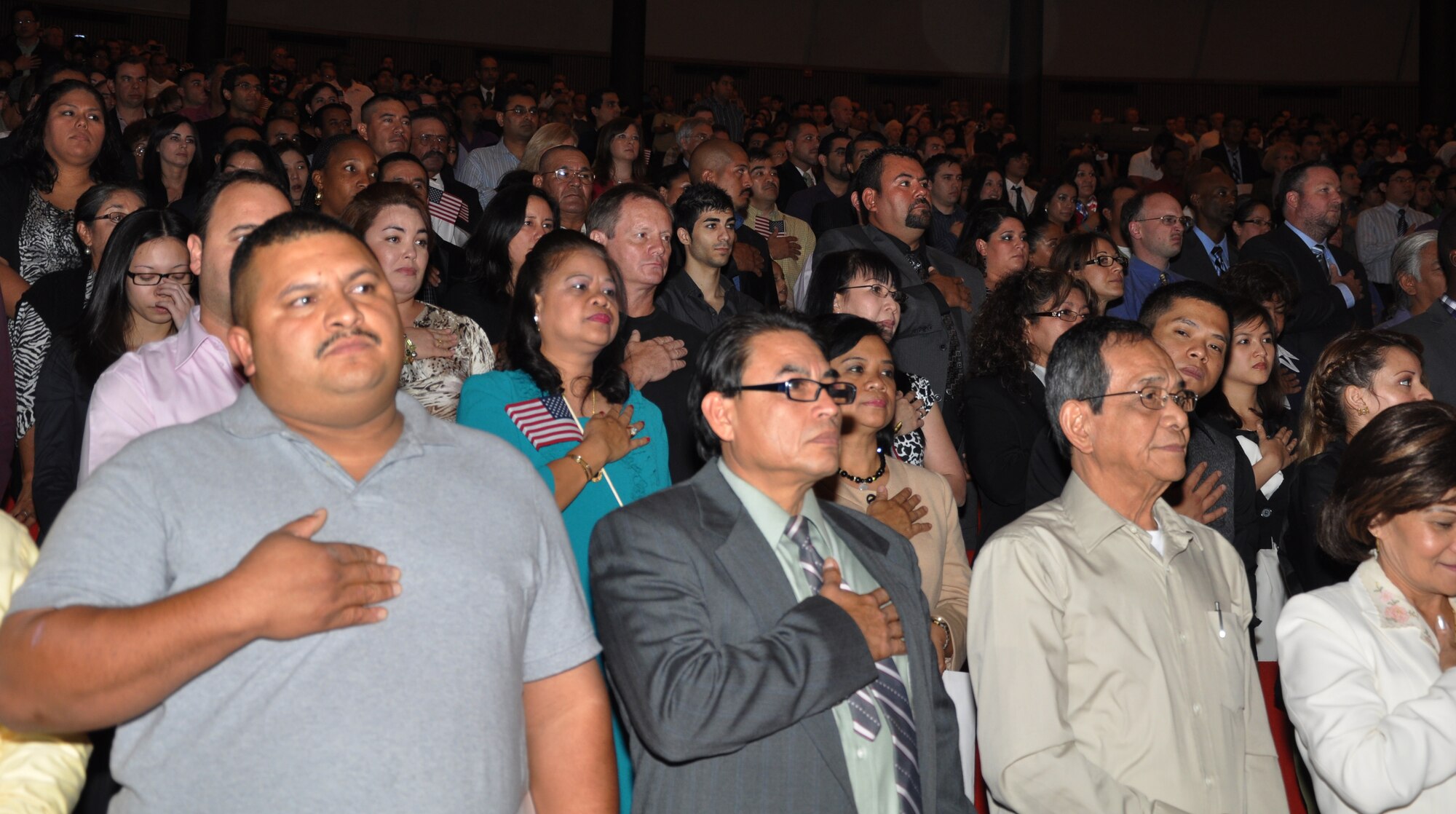 SAN ANTONIO, Texas – New U.S. citizens recite the Pledge of Allegiance Nov. 20 at a U.S. naturalization and citizenship ceremony at Trinity University’s Laurie Auditorium here. As the guest of honor, Gen. Edward A. Rice Jr., commander of Air Education and Training Command, addressed the 885 new citizens to welcome and encourage them to get the most out of the opportunity citizenship can bring. (U.S. Air Force photo/Dianne Moffett)