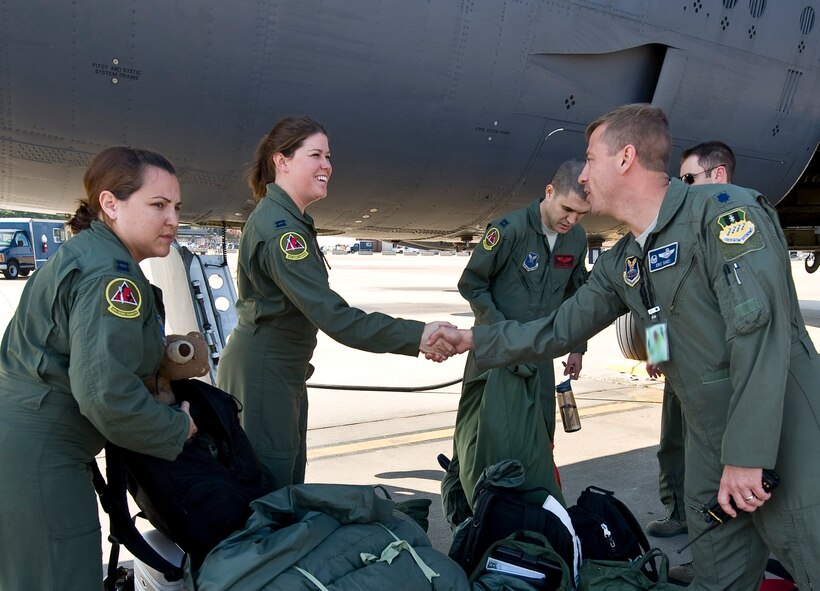 Lt. Col. Eric Sikes, 20th Bomb Squadron commander, greets aircrew members assigned to the 20 BS upon their return to Barksdale Air Force Base, La., Nov. 20. The Airmen are returning from Guam, where they were deployed in support of the continuous bomber presence there. (U.S. Air Force photo/Staff Sgt. Chad Warren)(RELEASED)