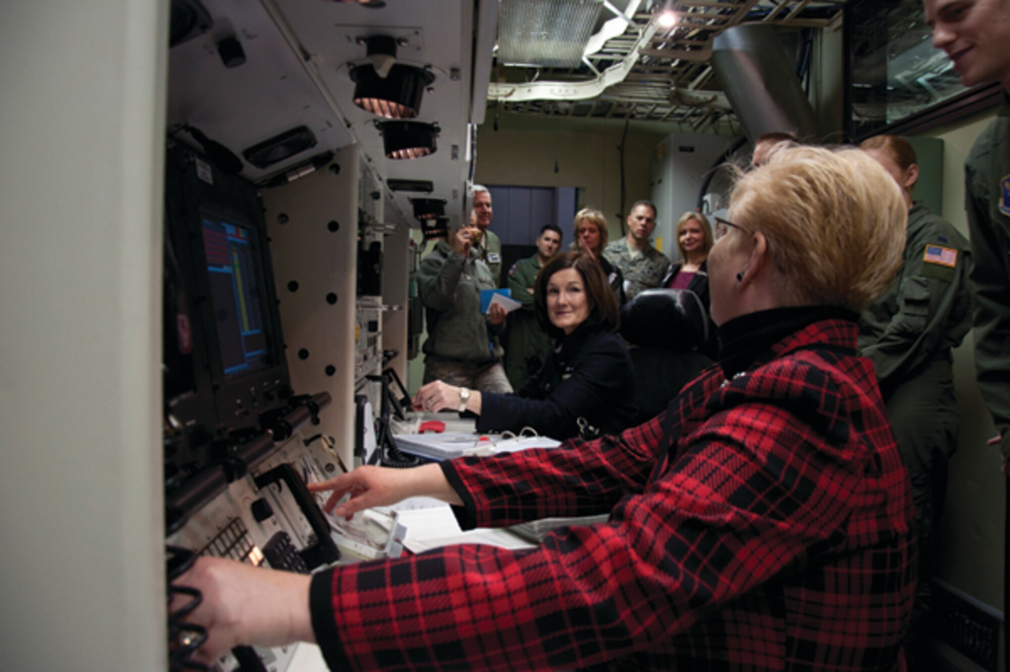 Betty Welsh, wife of Air Force Chief of Staff Gen. Mark A. Welsh III, and Paula Roy, wife of Chief Master Sgt. of the Air Force James Roy, prepare to "turn keys" inside Warren's Missile Procedures Trainer during their visit to F. E. Warren Air Force Base, Wyo., Nov. 19. (U.S. Air Force photo by Airman 1st Class Jason Wiese)