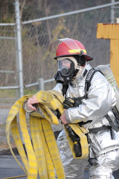 Civilian firefighter Jessica Hetrick drags a fire hose to put out a fake fire during fire fighting training on Nov. 20, 2012. Hetrick is a firefighter for the 193rd Special Operations Wing, Middletown, Pa. (U.S. Air Force Photo by Tech. Sgt Culeen Shaffer/Released)