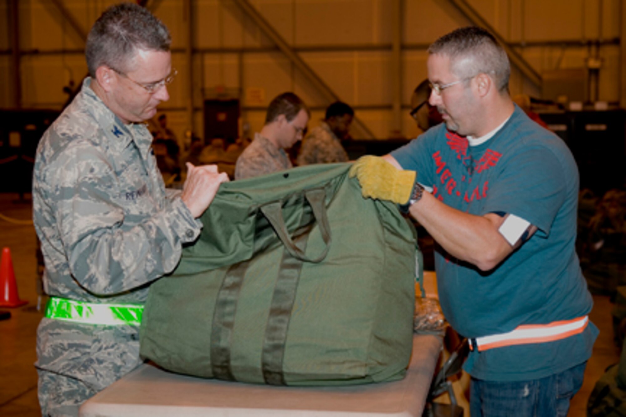 GRISSOM AIR RESERVE BASE, Ind. -- Col. Bryan Reinhart, 434th Air Refueling Wing vice commander, and Chad Malott, a government contractor with Data Management Systems, check a mobility bag during a mobility exercise here during a recent unit training assembly. (U.S. Air Force photo/Staff Sgt. Ben Mota)