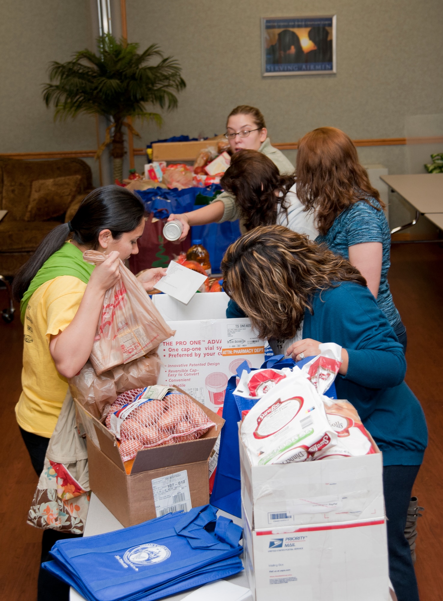 Volunteers sort and organize food donations into meal baskets as part of the Thanksgiving Basket Giveaway at the base chapel, Nov. 20, 2012, McConnell Air Force Base, Kan. The food was donated by Airmen from various base agencies and individuals and provided a traditional holiday meal for more than 160 McConnell families. (U.S. Air Force photo/Airman 1st Class Victor J. Caputo)