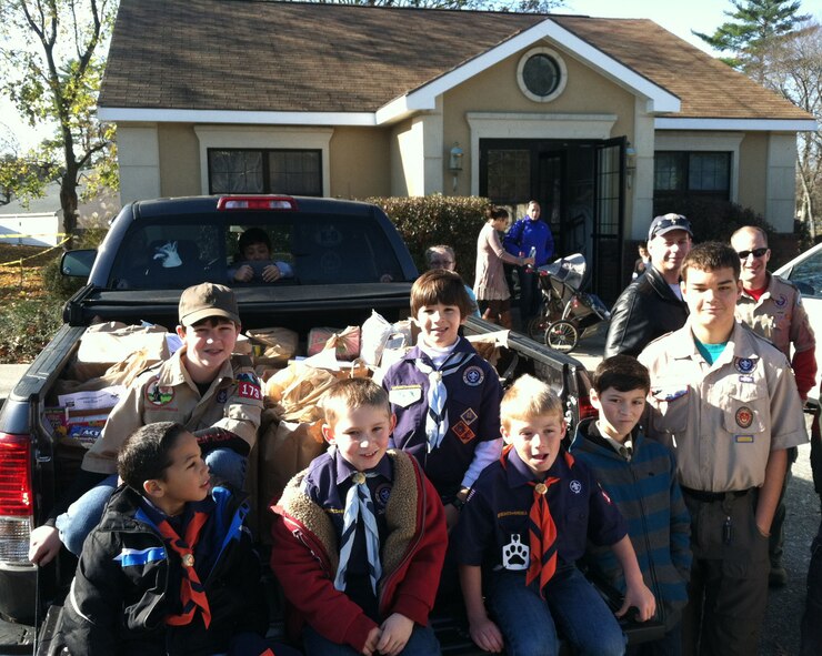 HANSCOM AIR FORCE BASE, Mass. - Hanscom Pack/Troop 173 gather in front of a truck full of food collected for the Bedford food pantry Nov. 10. This yearly community service event had Cub Scouts and Boy Scouts working together to advertise and collect non-perishable food from the Hanscom community. (Courtesy photo)