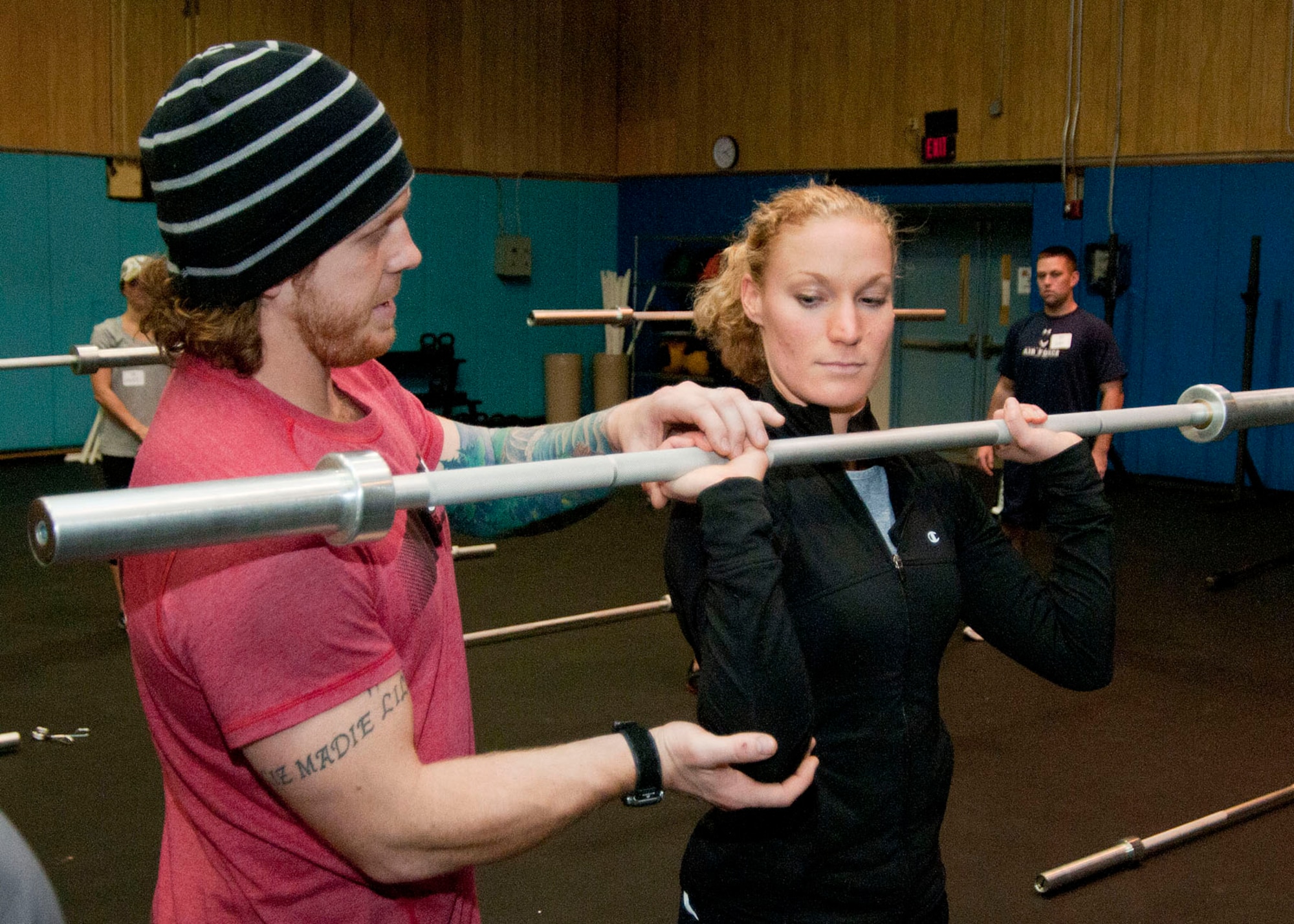 HANSCOM AIR FORCE BASE, Mass. -- Joe Degain, a CrossFit seminar staff member, instructs 1st Lt. Mallory Morgan on the proper holding position of the bar for front squats at the Fitness and Sports Center Nov. 14. CrossFit was on hand to conduct a two-day level one certification class.(U.S. Air Force photo by Mark Wyatt)