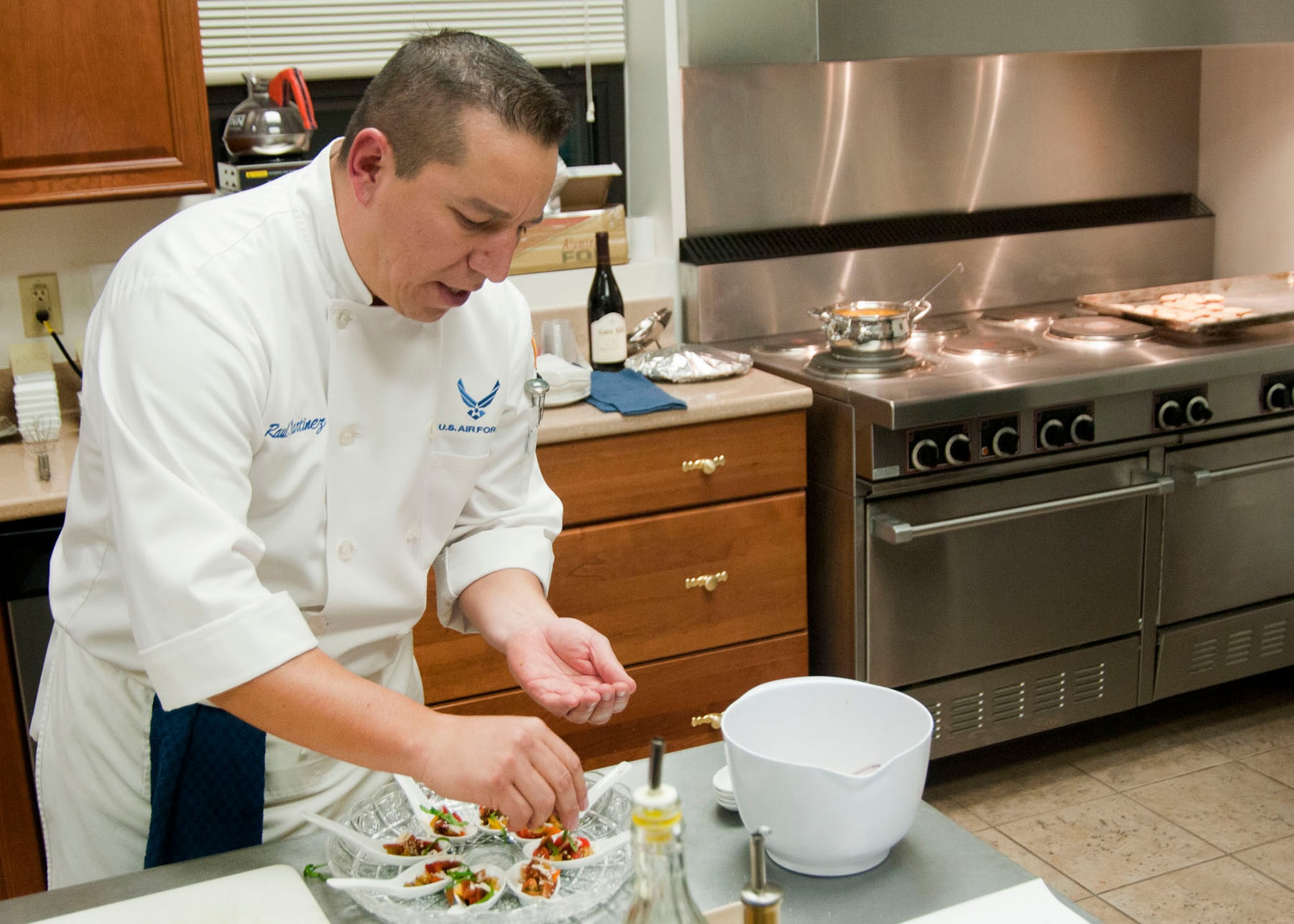 HANSCOM AIR FORCE BASE, Mass. -- Master Sgt. Raul Martinez prepares an appetizer at the Hanscom Conference Center Nov. 15 during a cooking class on how to prepare dishes during the holiday season. Martinez, a certified chef, taught this hands-on class focusing on holiday appetizers and sides. Additional classes are available Dec. 6 and Dec. 20 and cost $35 per person. (U.S. Air Force photo by Mark Wyatt)