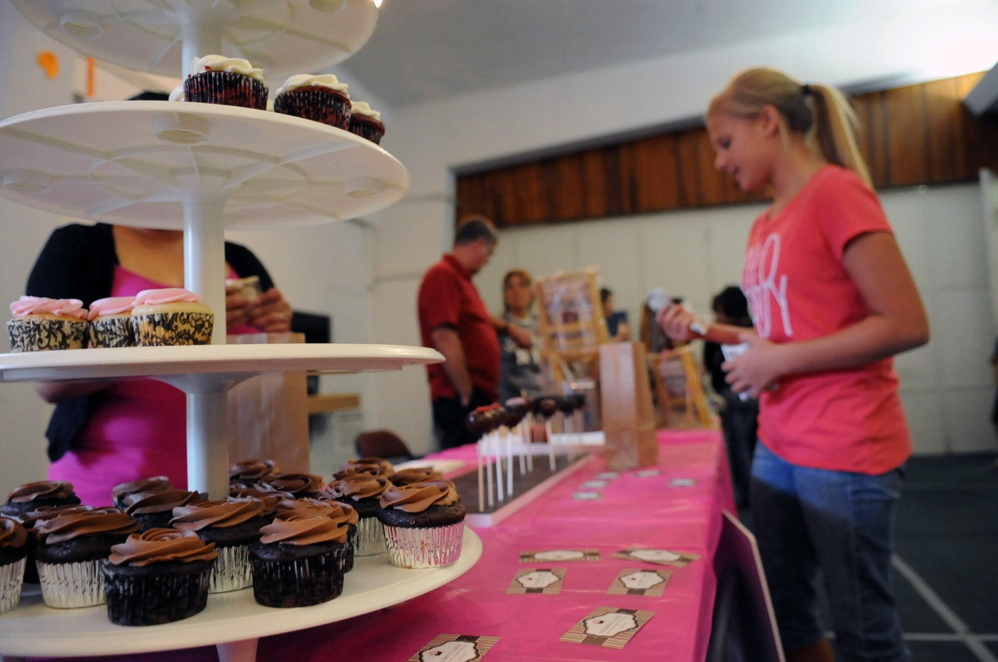 An Incirlik member buys a cupcake at the community center's holiday bazaar Nov. 17, 2012 at Incirlik Air Base, Turkey. Incirlik members visited the event to see what members of the community had to offer. Items available ranged from recycled art to baked goods. (U.S. Air Force photo by Senior Airman Daniel Phelps/Released)