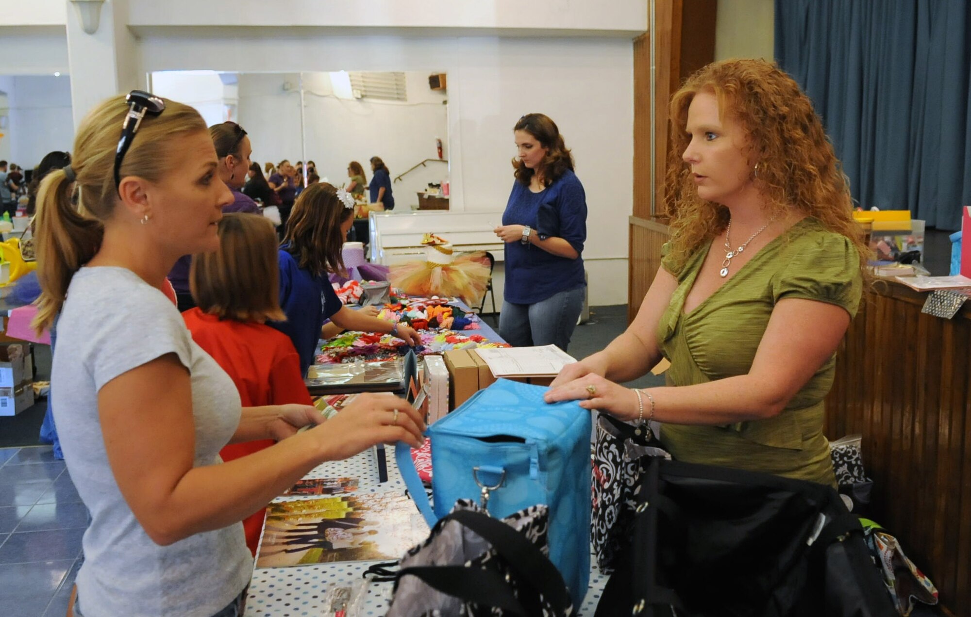 Kim Hasecuster, right, talks with Summer Woodruff, left, about handbags at the community center's holiday bazaar Nov. 17, 2012 at Incirlik Air Base, Turkey. Incirlik members visited the bazaar to see what other members of the community had to offer. (U.S. Air Force photo by Senior Airman Daniel Phelps/Released)