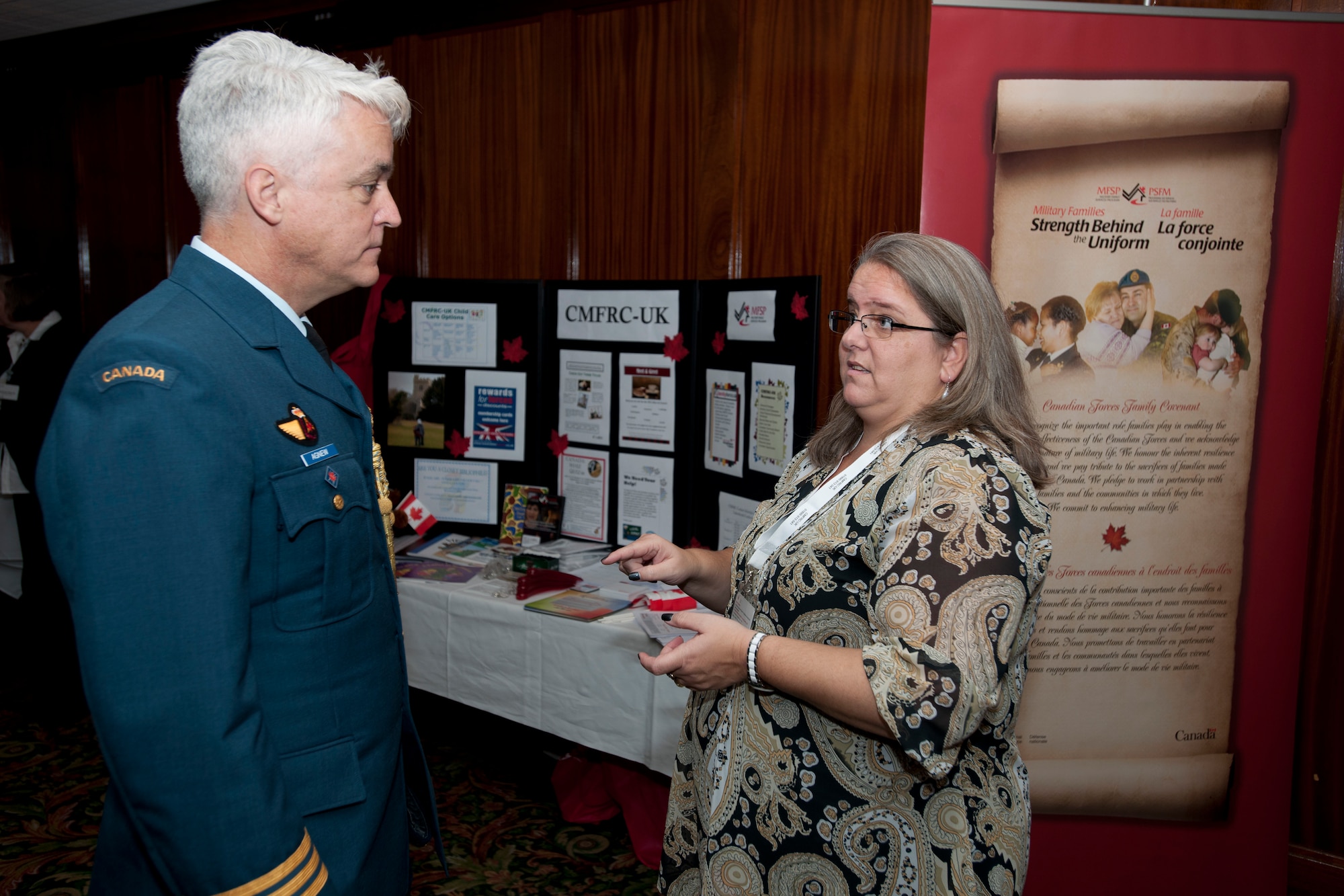 ROYAL AIR FORCE LAKENHEATH, England - Nancy Leblanc, Canadian Forces Support Unit community service provider, speaks with Royal Canadian Air Force Lt. Col. Arthur Agnew, High Commission of Canada in the U.K. assistant air advisor, London, U.K., about community services at the Canadian Forces U.K. Conference at Eagle's Landing Nov. 20, 2012. The CFSU hosted the conference, which provided an opportunity for officers and NCOs serving in the U.K. to interact with local government agencies, national government agencies and local support agencies. (U.S. Air Force photo by Staff Sgt. Stephen Linch)
