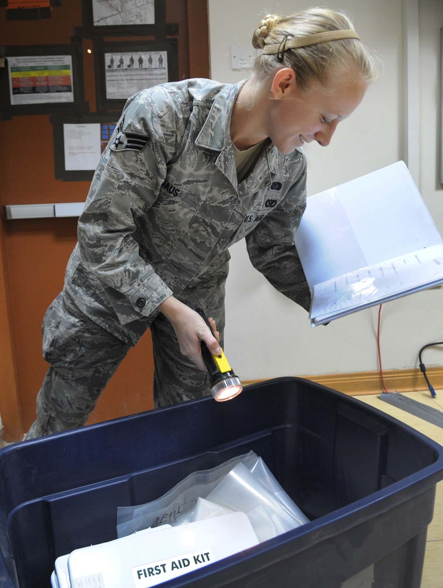 SOUTHWEST ASIA – Senior Airman Eva Gaus, 386th Expeditionary Civil Engineer Squadron emergency management programmer, inspects a shelter-in-place kit during a self- assisted visit here Nov. 20. Gaus organizes SAVs for every facility every six months. The inspection includes training programs, shelter-in-place, bunker and PAR kits, function checklists and the disaster response force. Gaus is stationed at the 14th Civil Engineer Squadron, Columbus Air Force Base, Miss. (U.S. Air Force photo/Staff Sgt. Alexandra M. Boutte)