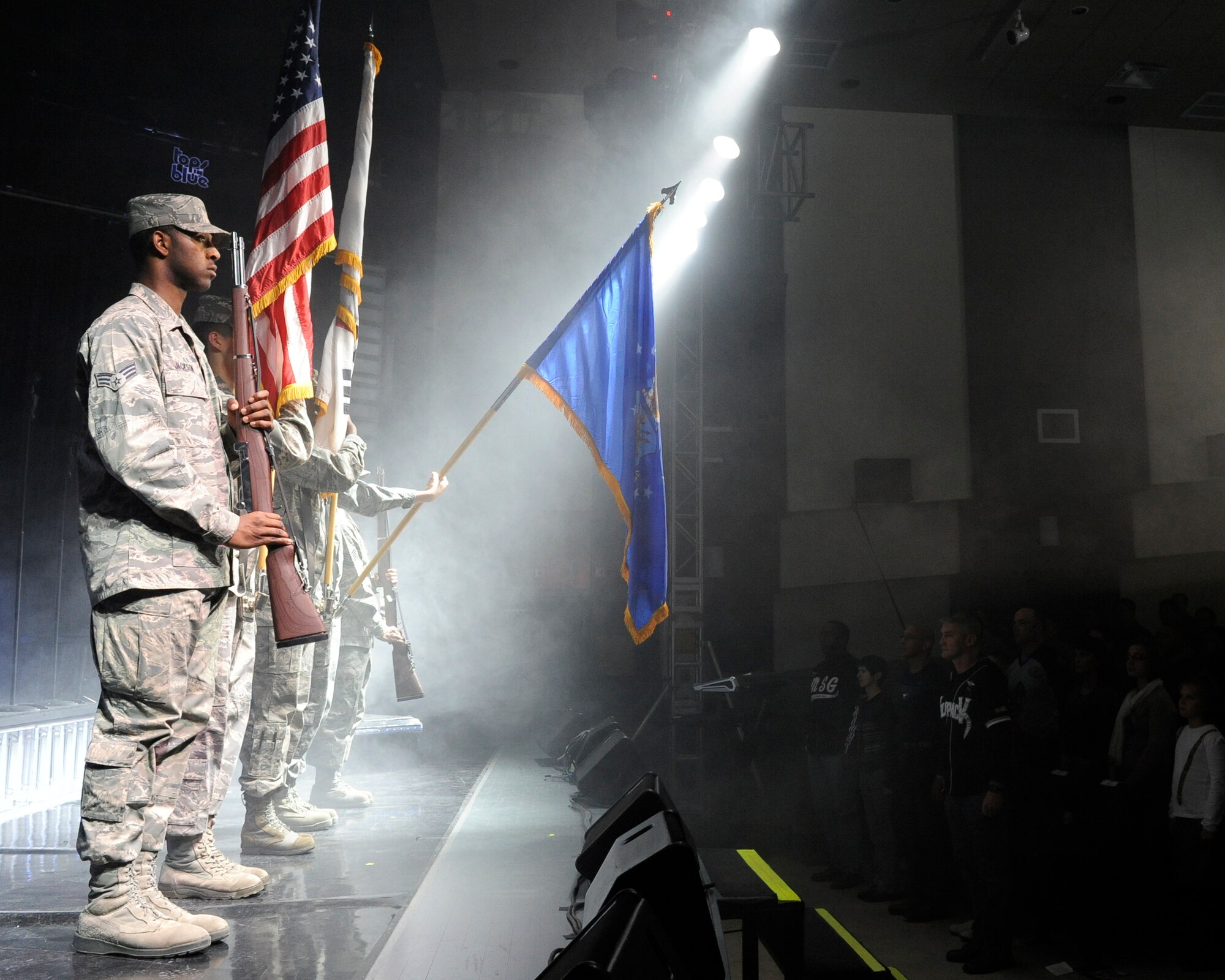 Kunsan honor guard Airmen post the colors for the national anthem during Tops in Blue performance at the base theater on Kunsan Air Base, Republic of Korea, Nov. 20, 2012. Tops in Blue serves as an expeditionary entertainment unit to provide quality entertainment from within Air Force resources for the Air Force family, with priority to Air Force personnel stationed worldwide at remote and deployed locations.
 (U.S. Air Force photo/Senior Airman Marcus Morris)
