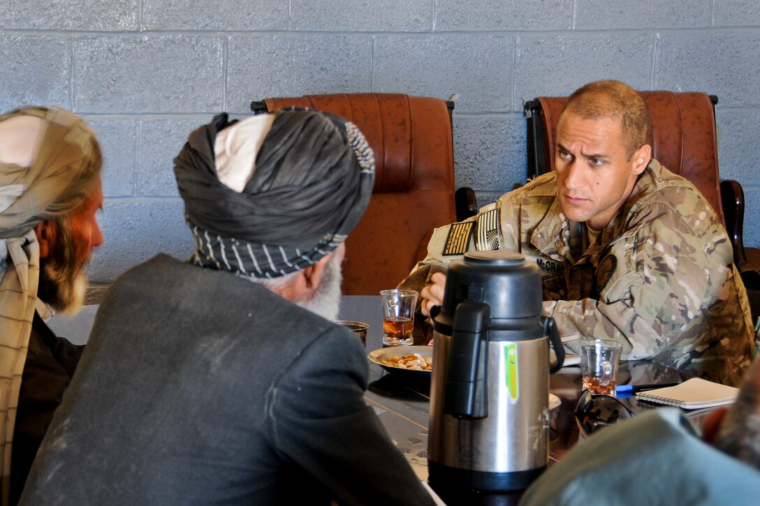 U.S. Navy Cmdr. Louis McCray, right, listens to district government leaders at the Pusht-e Rod district center in Afghanistan's Farah province, Nov. 19, 2012. McCray is the commanding officer for Provincial Reconstruction Team Farah. The team's mission is to train, advise and assist Afghan government leaders at the municipal, district, and provincial levels in the province. 