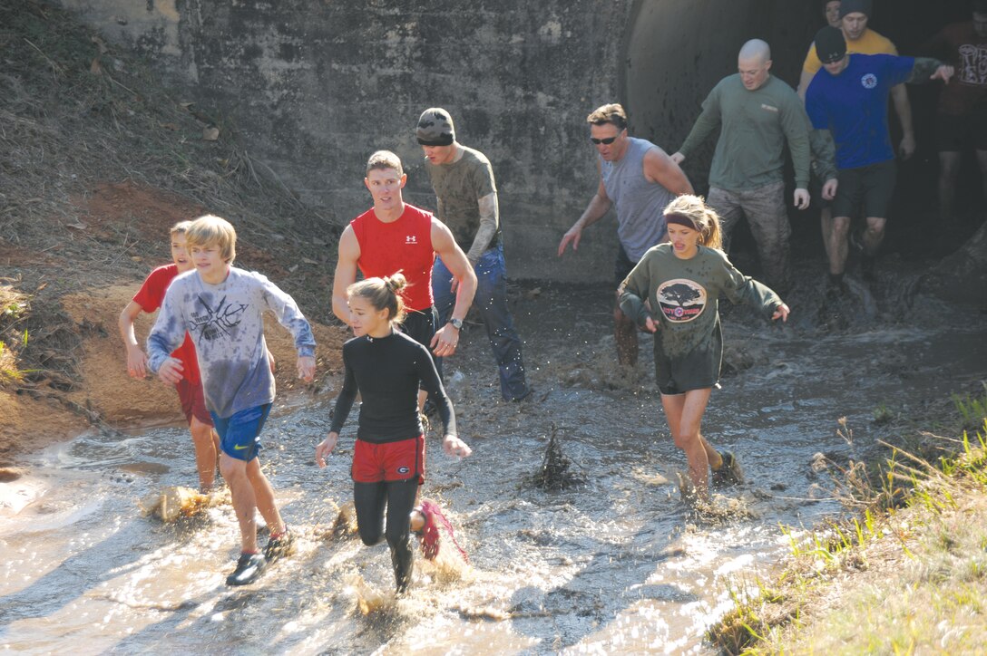 More than 550 people participated in Marine Corps Logistics Base Albany’s first Dirty Devil Dog Mud Run, Nov. 17. Sloshing through canals, jumping barricades and low crawling through mud pits were just a few of the obstacles runners endured. 