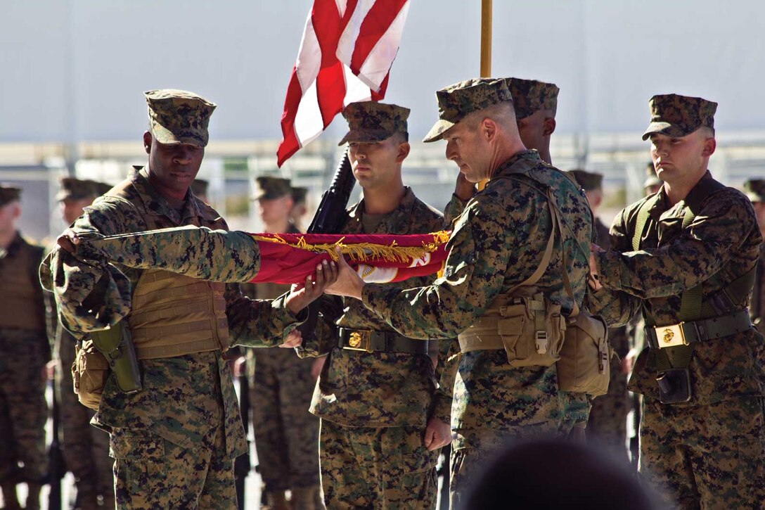 Left, Sergeant Maj. Carlos Williams, Marine Fighter Attack Squadron 121 sergeant major, and right, Lt. Col. Jeffrey Scott, VMFA-121 commanding officer, unfurl the VMFA-121 colors during the squadron re-designation ceremony Nov. 20 at the VMFA-121 hangar, Marine Corps Air Station Yuma, Ariz. Special guests; Senator John McCain, Arizona state Senator, Governor Janice K. Brewer, Arizona state Governor, The Honorable Mr. Robert O. Work, Under Secretary of the Navy and General James F. Amos, Commandant of the Marine Corps were in attendance for the ceremony and spoke of the great contribution to Marine Corps aviation.