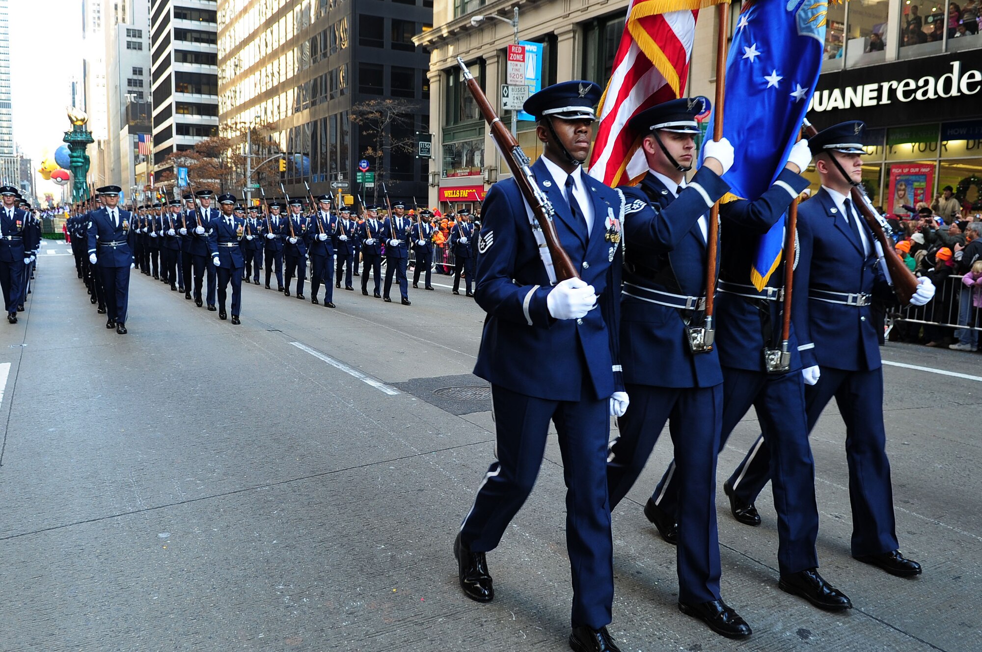 U.S. Air Force Honor Guard Colors Team members lead ceremonial guardsmen during the 86th Annual Macy?s Thanksgiving Day Parade, 2012, in New York City. The USAF Honor Guard and Band made history when they set foot in the city for the largest deployment of 11th Operations Group assets outside of the National Capital Region in support of the parade for the very first time. (U.S. Air Force photo by Senior Airman Steele C. G. Britton)