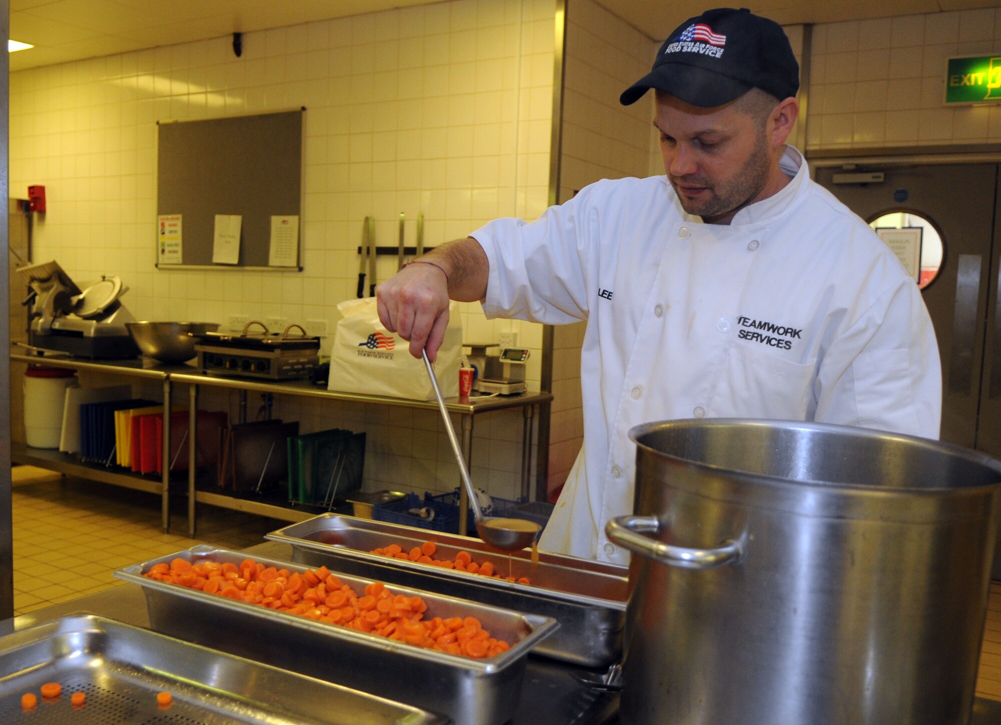 Lee Adamson, 100th Force Support Squadron contract chef, prepares glazed carrots for the Thanksgiving lunch served in celebration of the American holiday Nov. 22, 2012, at the Gateway Dining Facility, RAF Mildenhall, England. The 100th FSS prepared the feast to allow American service members and their families stationed in England to enjoy the holiday.. (U.S. Air Force photo by Staff Sgt. Austin M. May/Released)